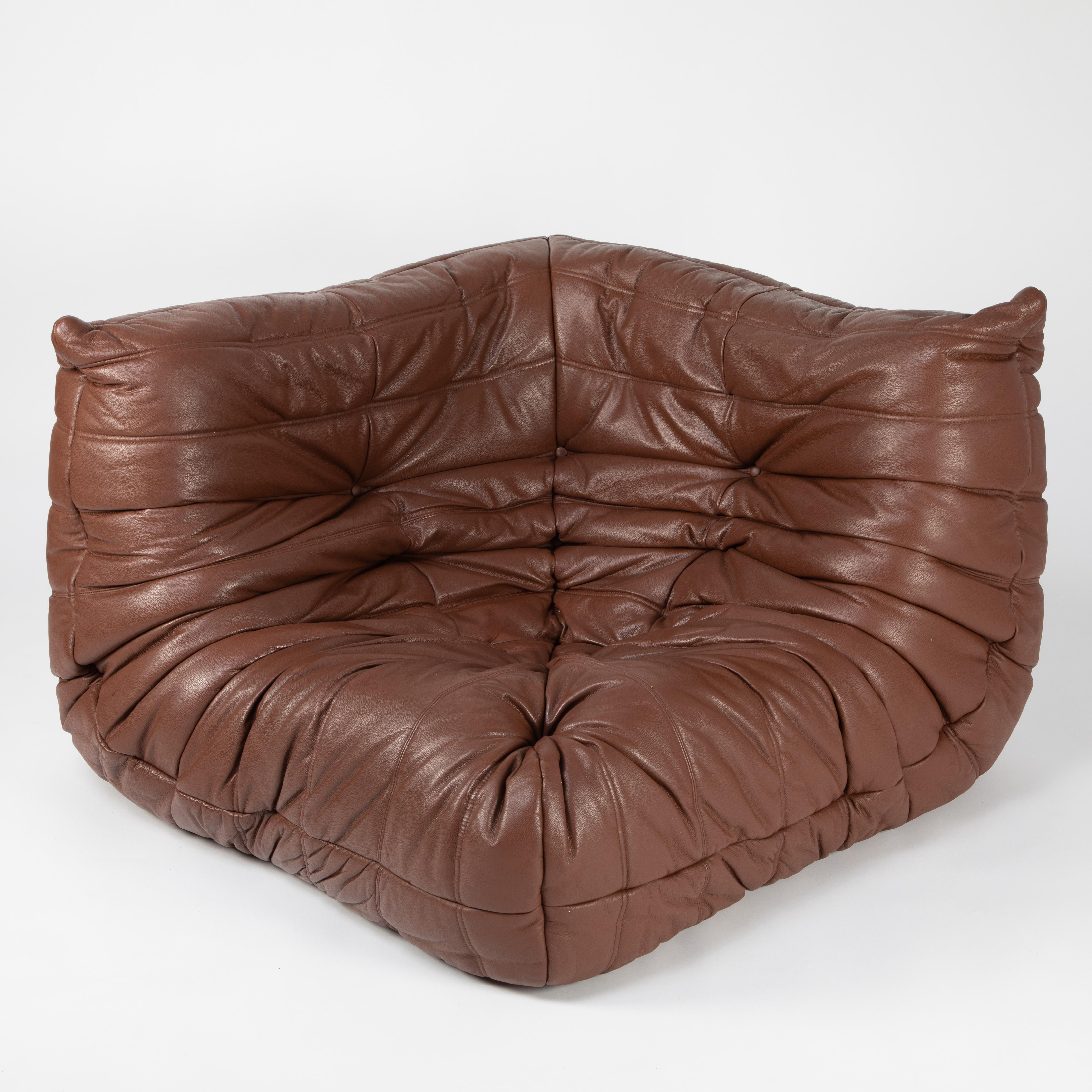Extraordinarily comfortable classic corner chair from French designer Michel Ducaroy's Togo line for Ligne Roset. Designed in 1973, the Togo collection features ergonomic all-foam forms with quilted covers, this example in a lovely whiskey-color