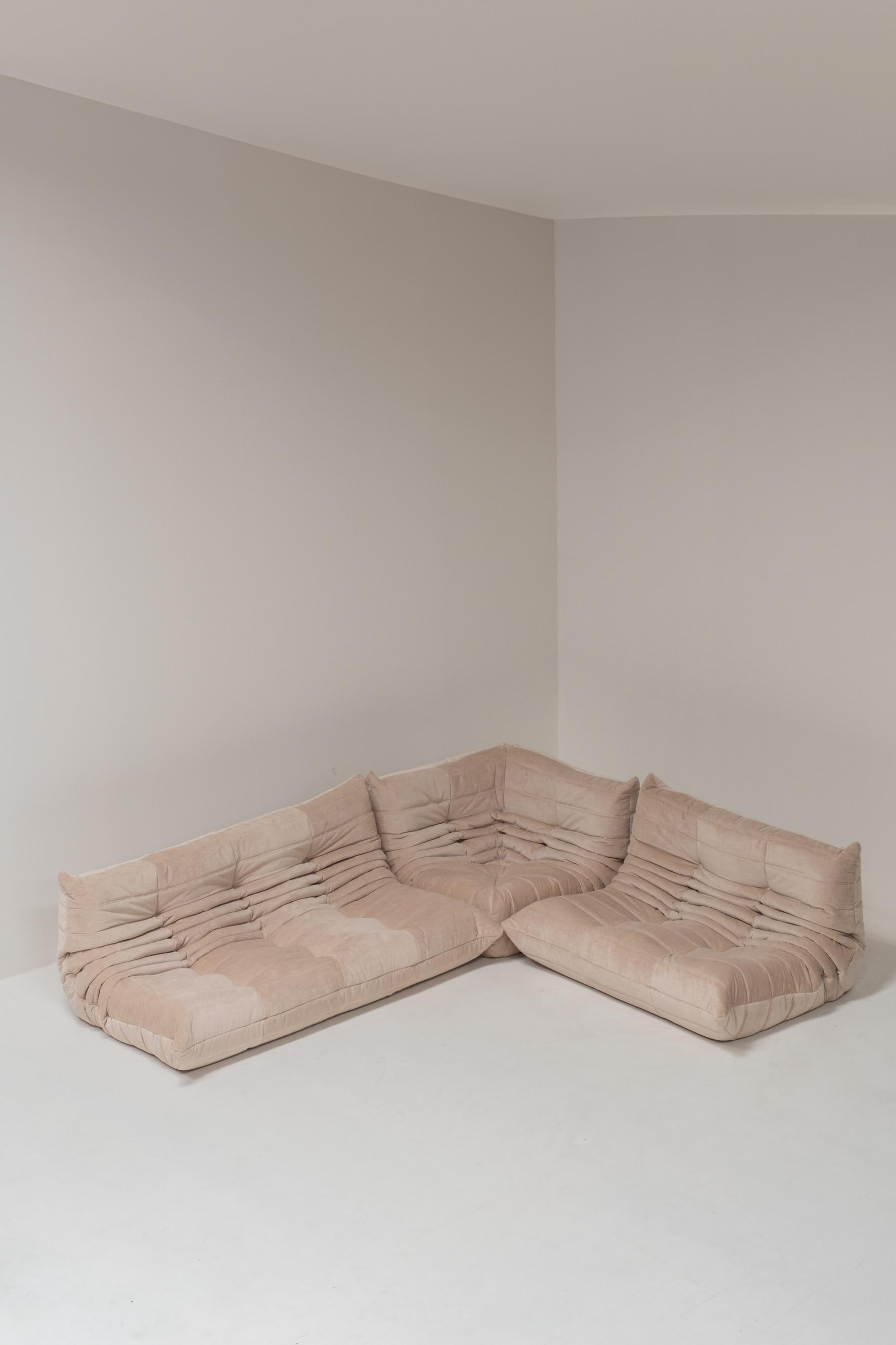Presenting a vintage Ligne Roset Togo set, fully reupholstered in a luxurious beige high-value textile with a subtle relief texture. This set includes a 3-seater, a corner module, and a 2-seater—perfectly designed to add both comfort and style to