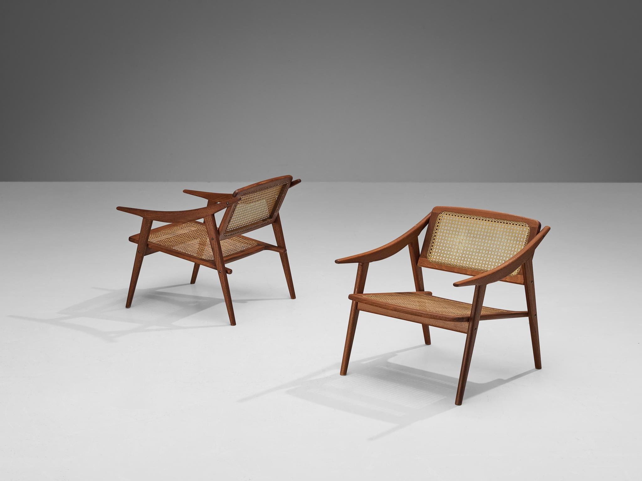 Michel Ducaroy for SNA Roset, pair of armchairs, teak, cane, France, 1950s

In the 1950s, the French designer Michel Ducaroy designed these elegant lounge chairs as part of his collection for his own furniture company, SNA Roset. These chairs are a