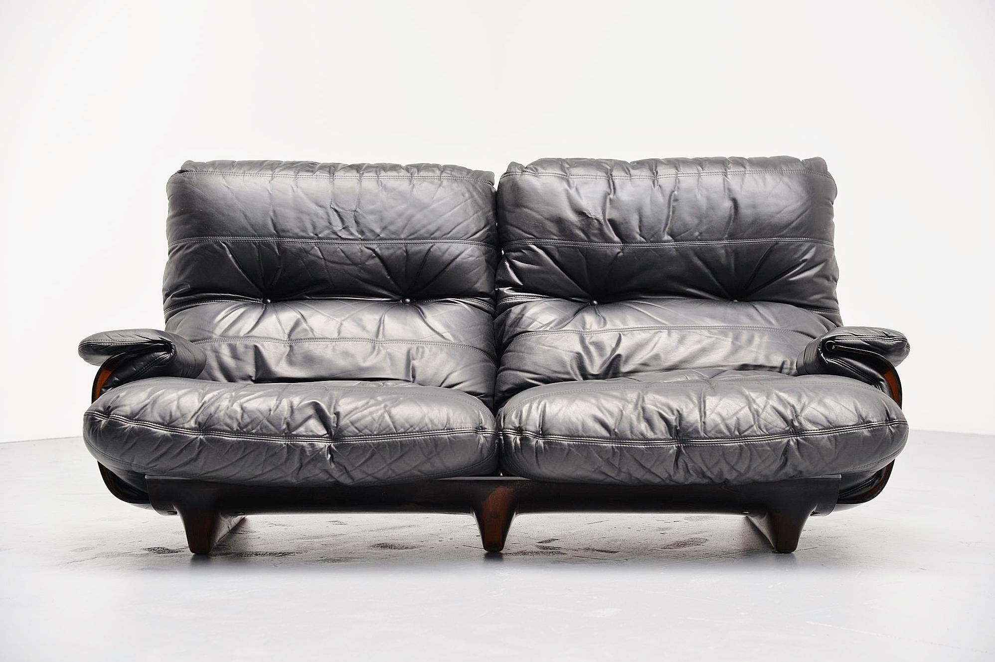 Large lounge sofa designed by Michel Ducaroy, manufactured by Ligne Roset, France, 1970. This is from the Marsala series and this has a brown Plexiglas base and very cozy black leather cushions. Super comfortable lounge sofa in high quality leather.