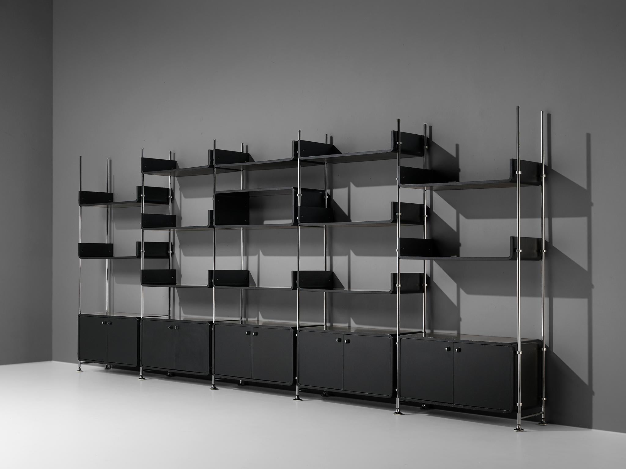 Michael Ducaroy, free-standing wall unit, steel, lacquered wood, France, 1970s

Michael Ducaroy designed this free-standing wall unit in the 1970s. In five columns are five closed cabinet and multiple shelves to find. The black lacquered wood is