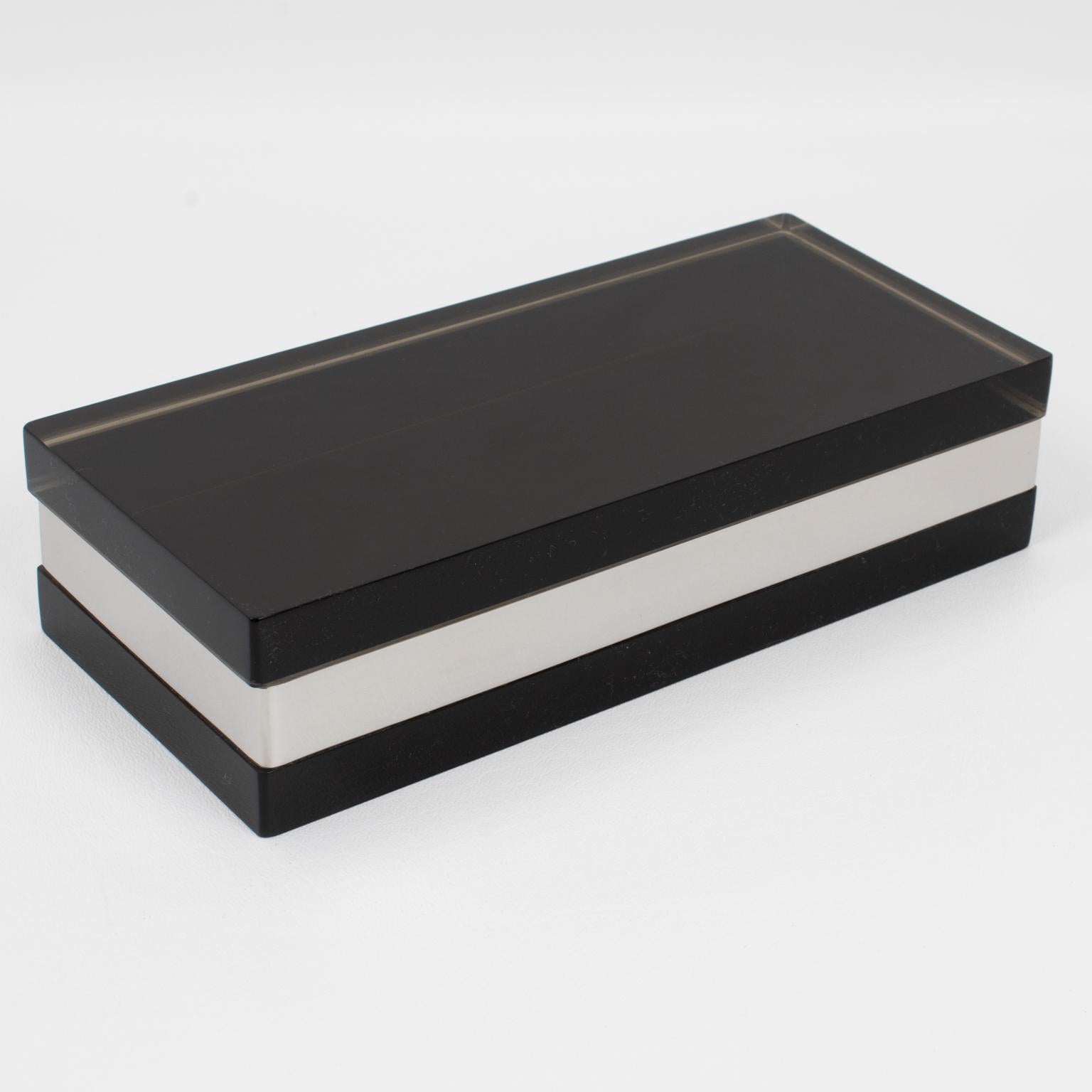 Michel Dumas Creations designed this sophisticated modernist Lucite and chrome box for Roche Bobois in France. Crafted circa 1970, this stunning, rare decorative piece features a rectangular shape with an extra-thick, smoked gray Lucite slab serving