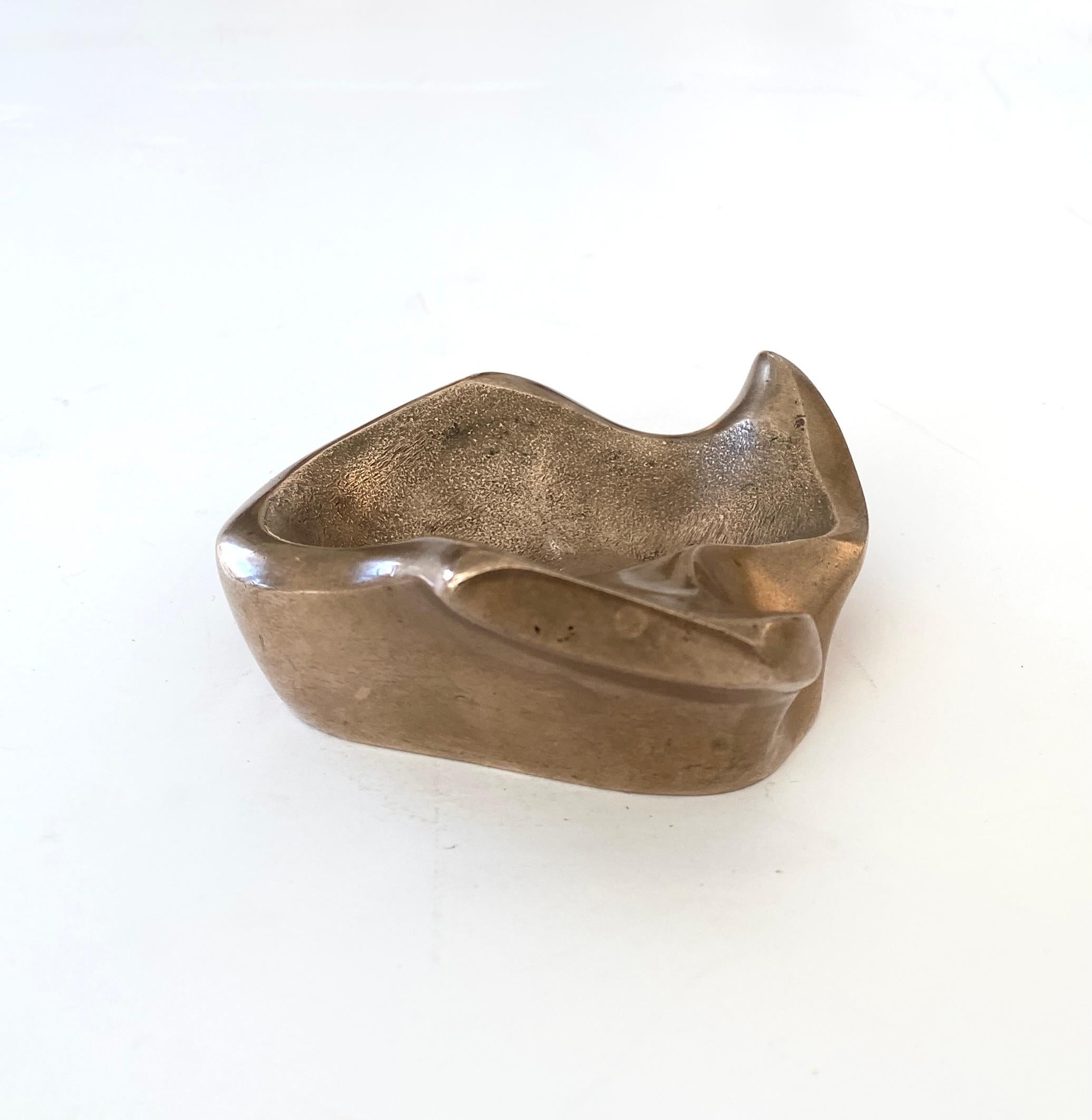 Michel Jaubert abstract sculptural bronze vide poche or dish. Michel Jaubert was well known for his sculptural abstract lamps created in bronze in his French atelier. Also created were many abstract small sculptures but more rare. 
Signed M Jaubert.