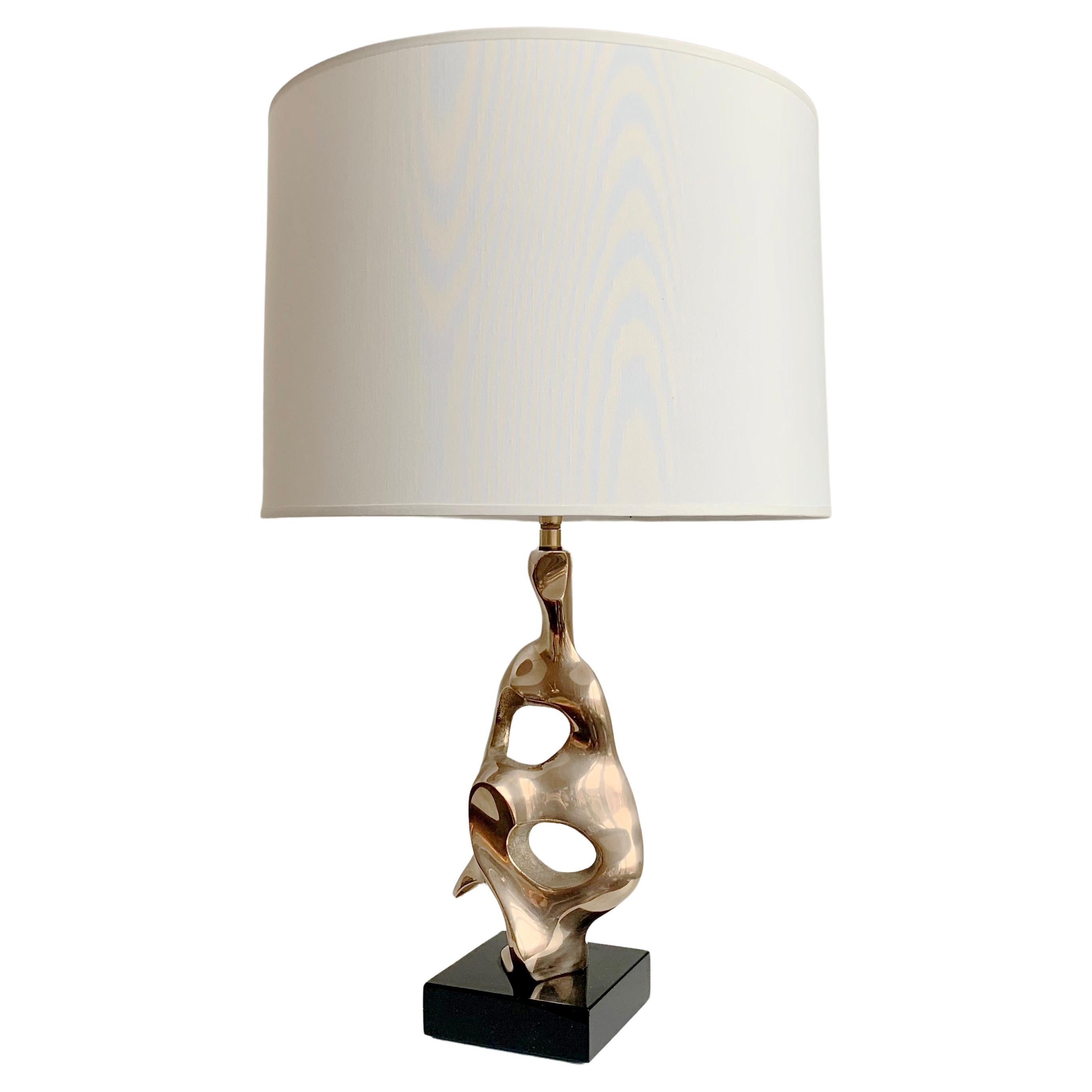 Nice Michel Jaubert signed sculptural table lamp, circa 1975, France.
Polished bronze organic form, black lacquered wood base, new white fabric shade.
Signed M.Jaubert on the bronze.
Rewired.
Dimensions: total height: 51 cm. Diameter of the shade:
