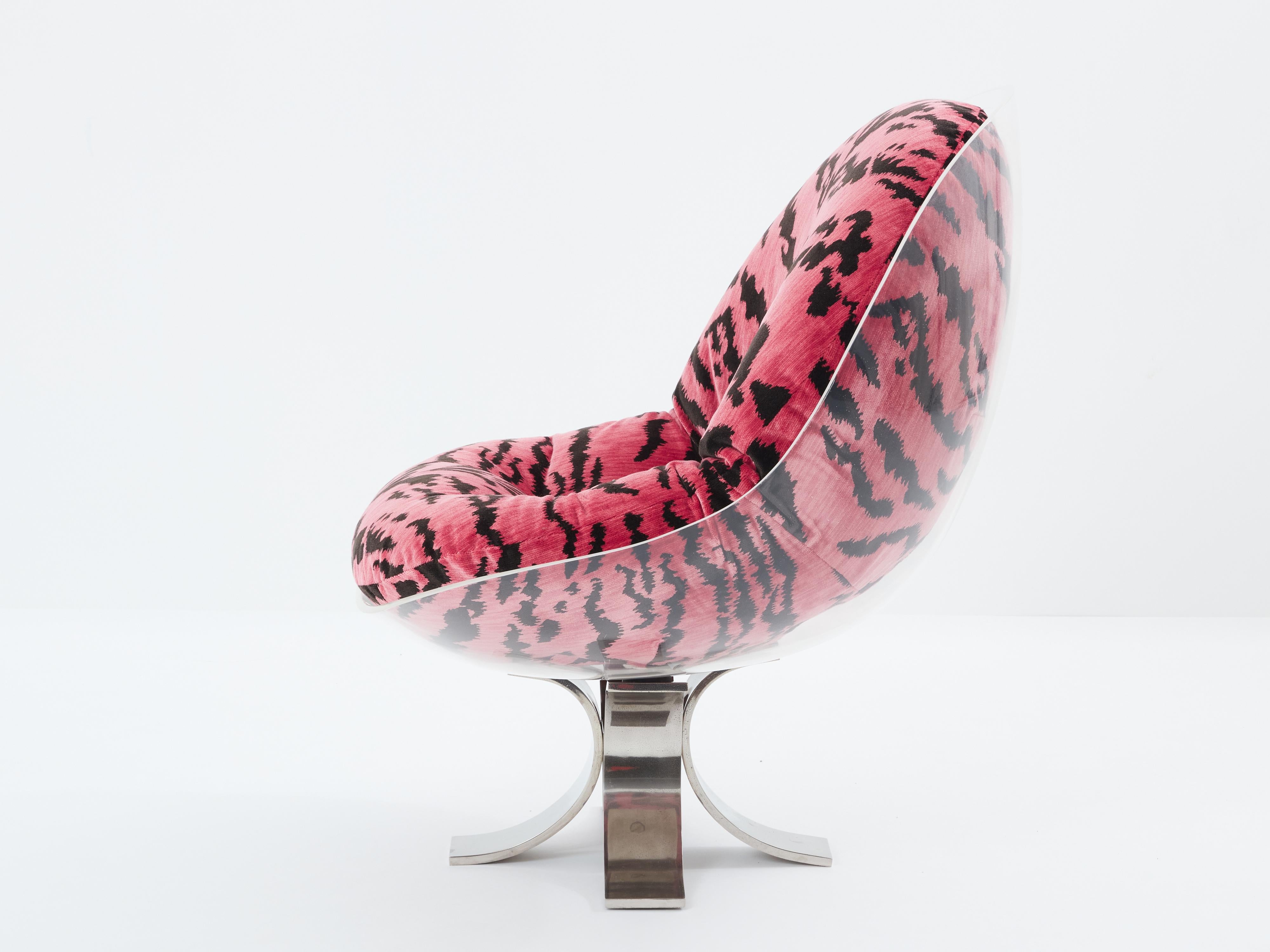 This rare and distinctive egg chair is a creation by Michel Pigneres, dating back to 1972. It is crafted with a transparent altuglas shell, mounted on curved steel blades, attached together by four big flat screws. Its cushion has been reupholstered