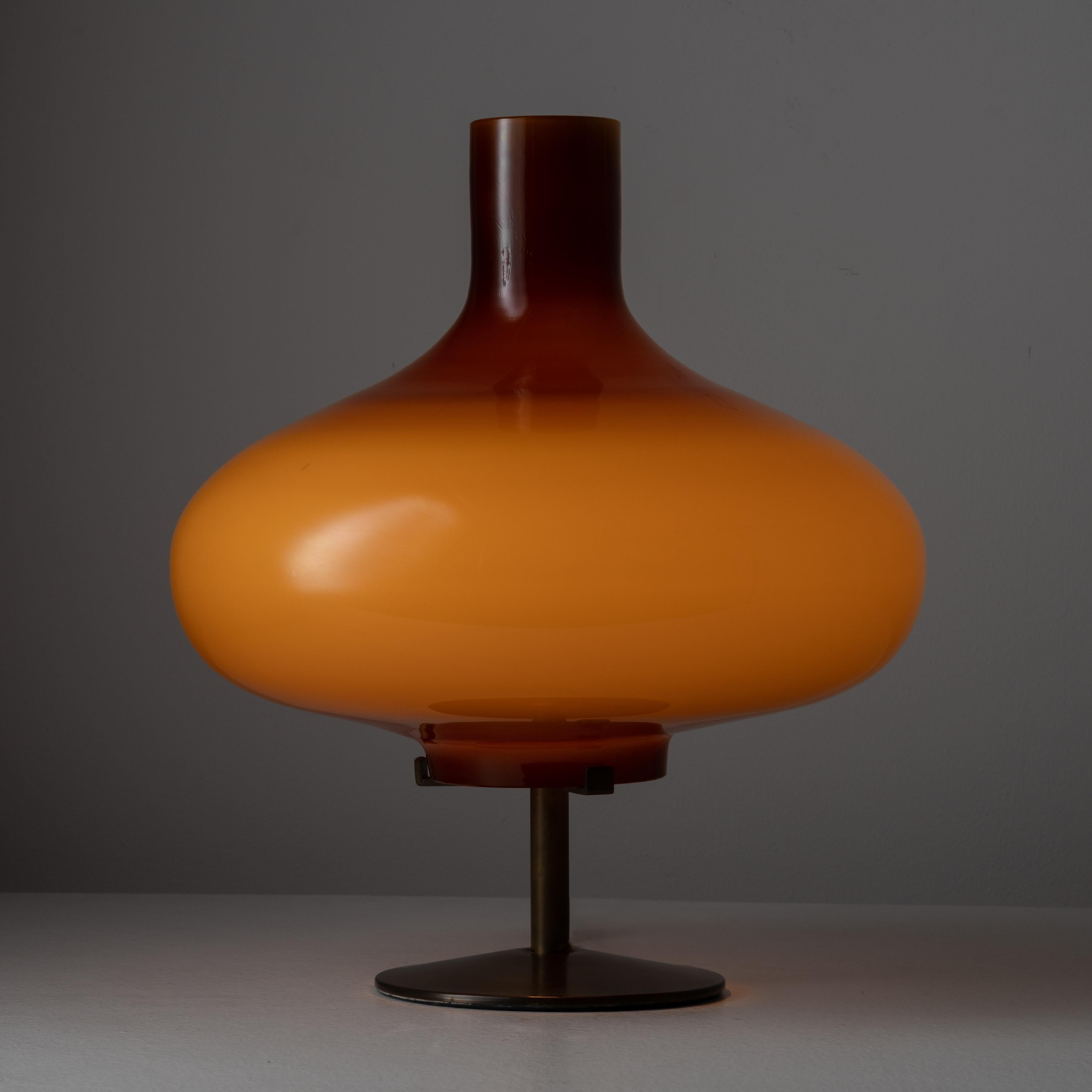 'Michela' Table Lamp by Annig Sarian for Adrasteia. Designed and manufactured in Italy, in 1958. Incredible custom orange opaline glass table lamp with a solid brass base and frame. The table lamp holds one E27 socket, adapted for the US. We