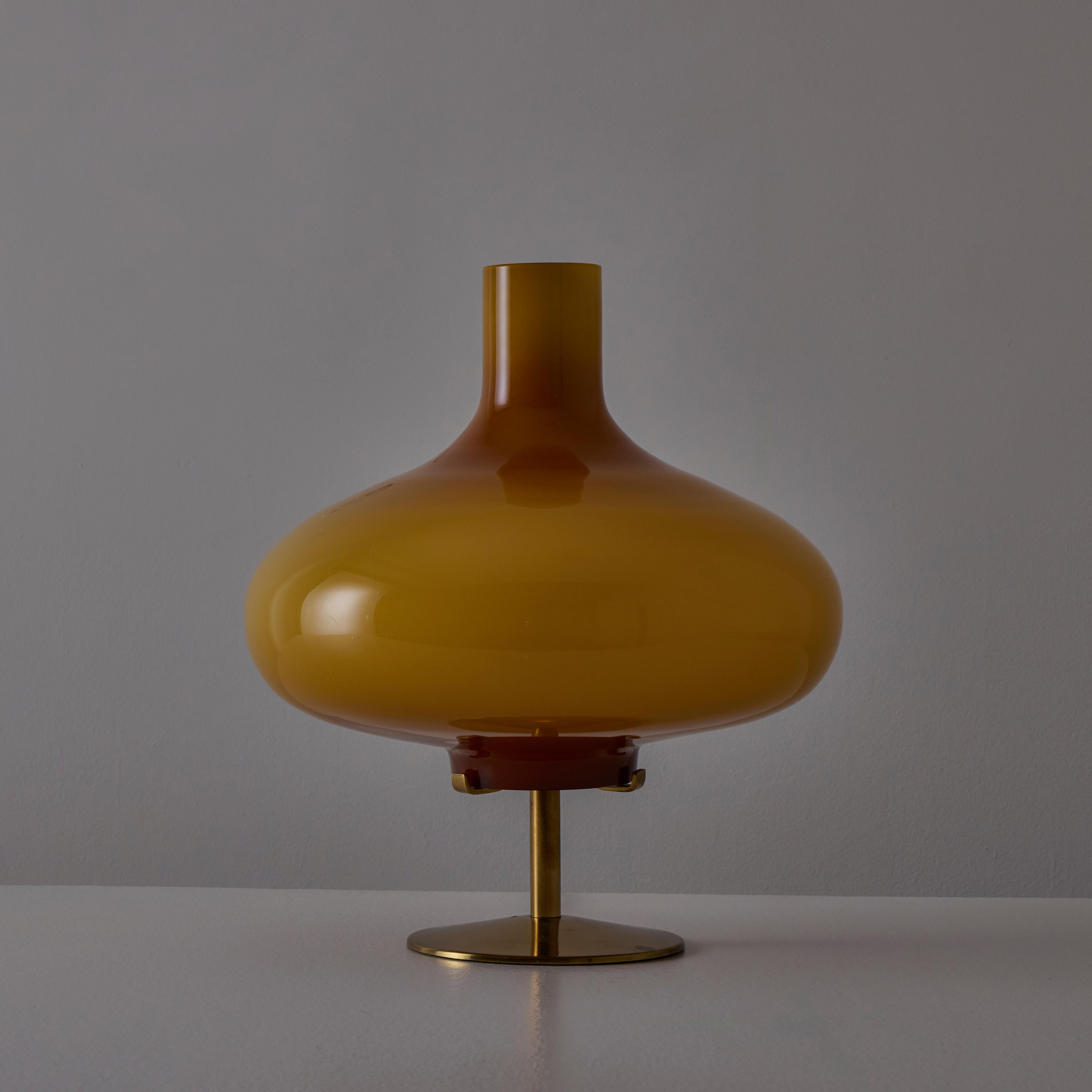 'Michela' Table Lamp by Annig Sarian for Adrasteia. Designed and manufactured in Italy, in 1958. Incredible custom orange opaline glass table lamp with a solid brass base and frame. The table lamp holds one E27 socket, adapted for the US. We