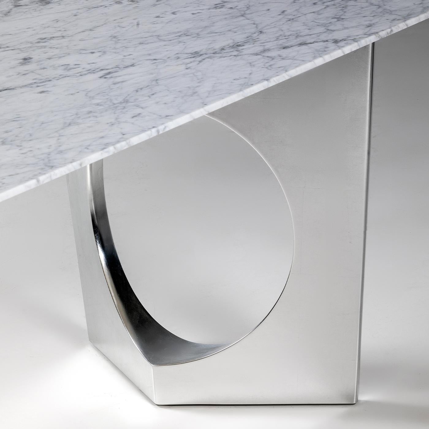 Entirely crafted of white Carrara marble, the Michelangelo Table boasts a sublimely smooth surface and sleek aesthetic that exudes an air of modern glamour. The linear and attractive design by Carlo Bimbi is defined by two architectural legs created