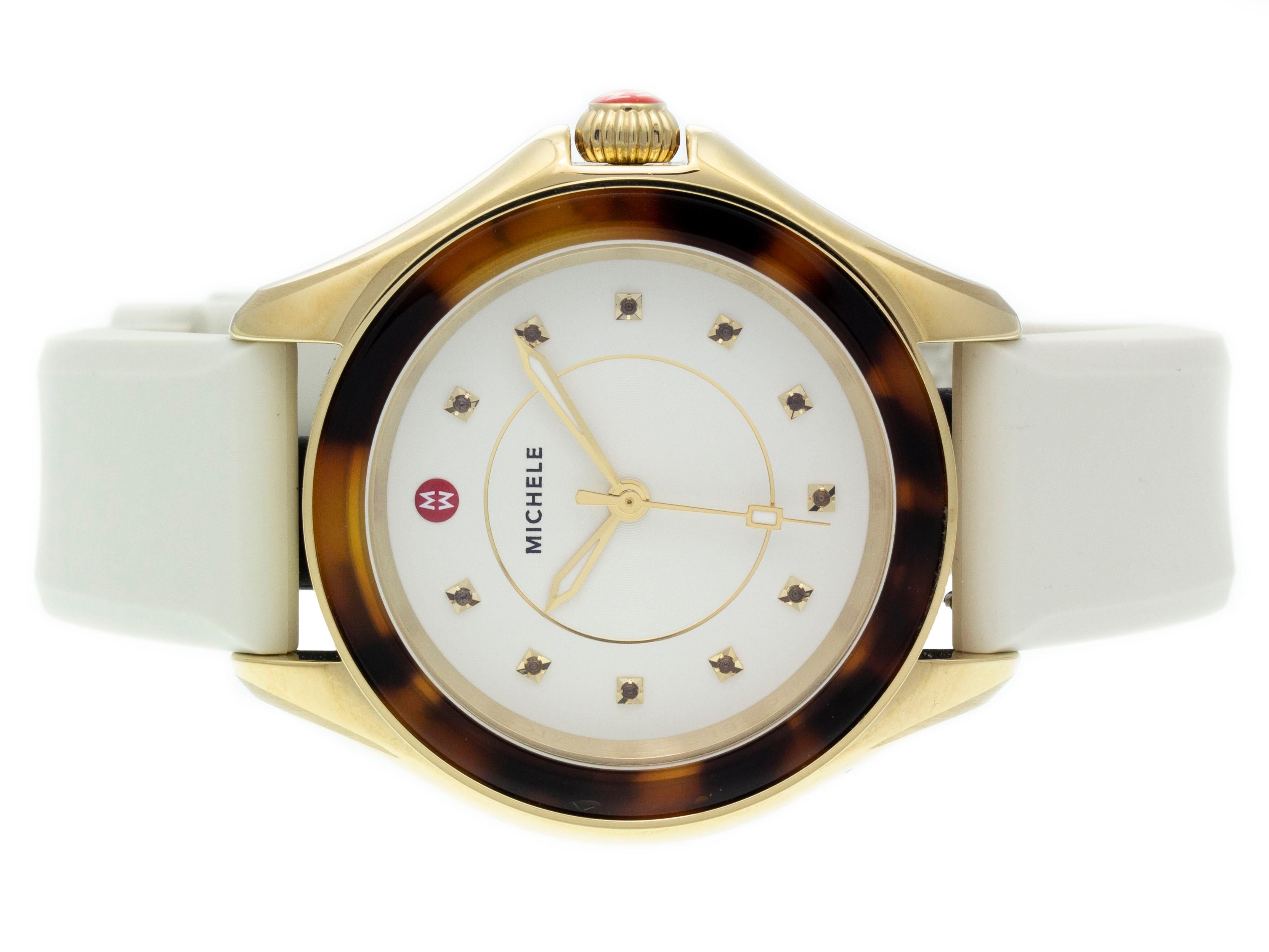 PVD steel Michele Cape quartz watch with a 40mm case, cream dial with topaz indexes, and silicone strap with tang buckle. Features include hours, minutes, and seconds. Comes with a Deluxe Gift Box and 2 Year Store