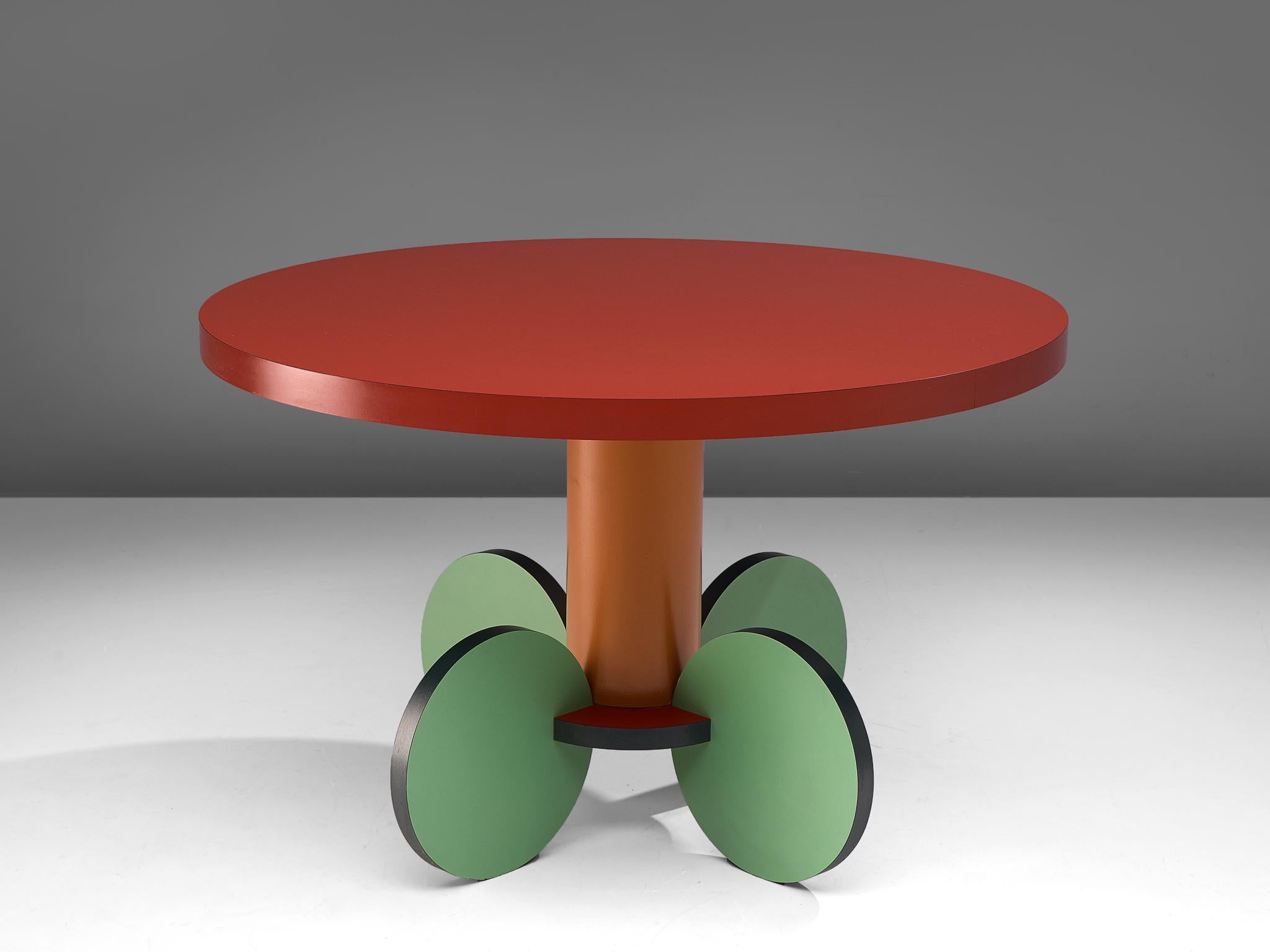 Michele de Lucchi, dining table 'La Festa', laminated wood, Italy, 1984.

Postmodern round dining or center table named La Festa, designed by the Italian Michele de Lucchi. The table features a circular table top in red laminated wood, resting on