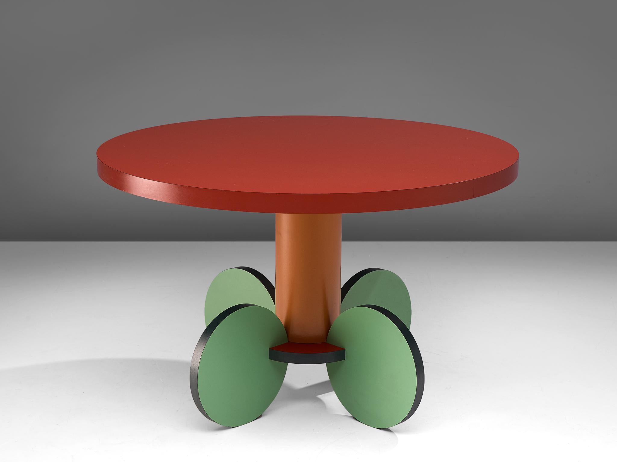 Michele de Lucchi, dining table 'La Festa', laminated wood, Italy, 1984.

Postmodern round dining or center table named La Festa, designed by the Italian Michele de Lucchi. The table features a circular table top in red laminated wood, resting on
