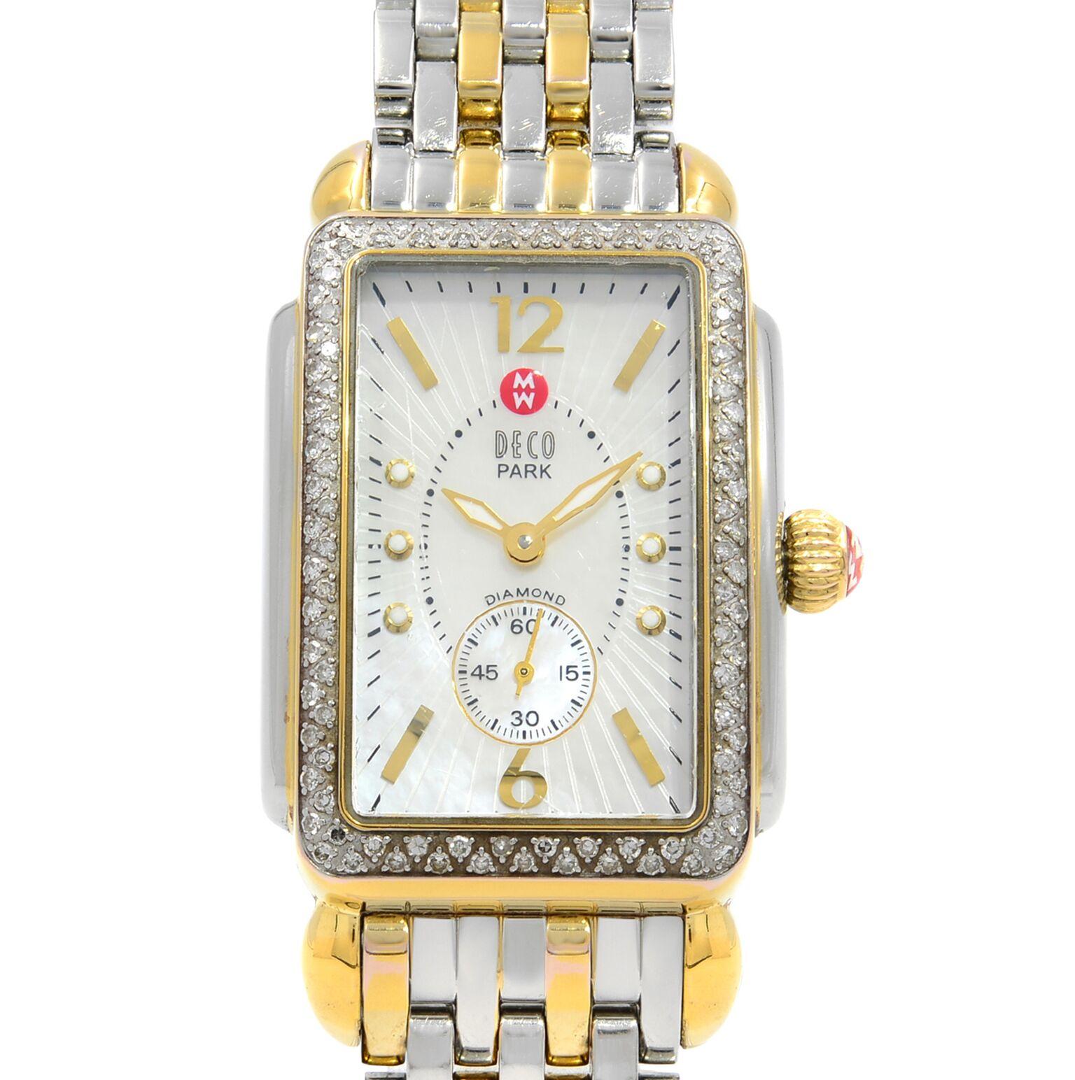 This pre-owned Michele Deco MW06M01C5025 is a beautiful Ladies timepiece that is powered by a quartz movement which is cased in a stainless & plated metal case. It has a  rectangle shape face,  dial and has hand dots, sticks & numerals style