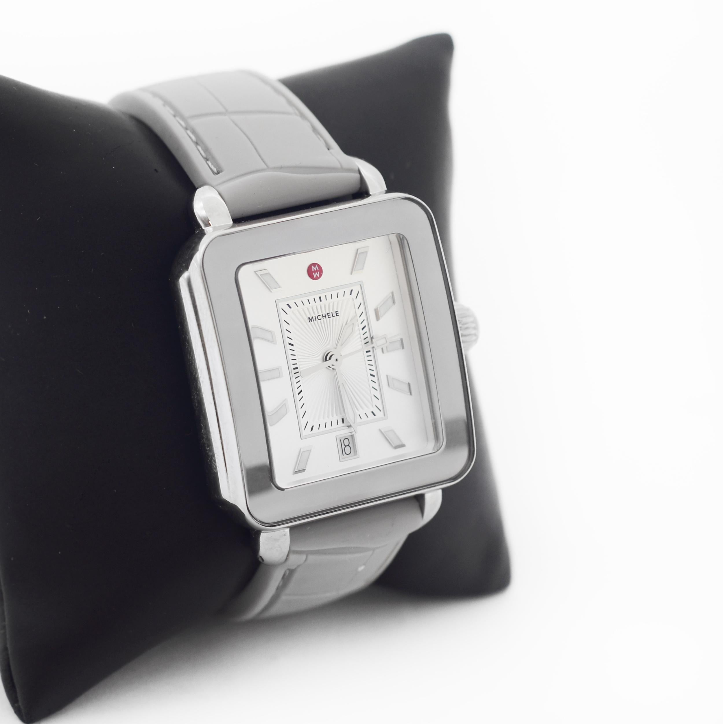 MICHELE
DECO SPORT
With Manufacturer Serial Numbers
Sunray White Silver Dial
Luminescent Hands & Hour Markers
Polished Stainless Steel Fixed Bezel
Date Feature at 6 o'clock mark
Battery Operated Quartz Movement
Swiss Made Movement
50 Meters / 165