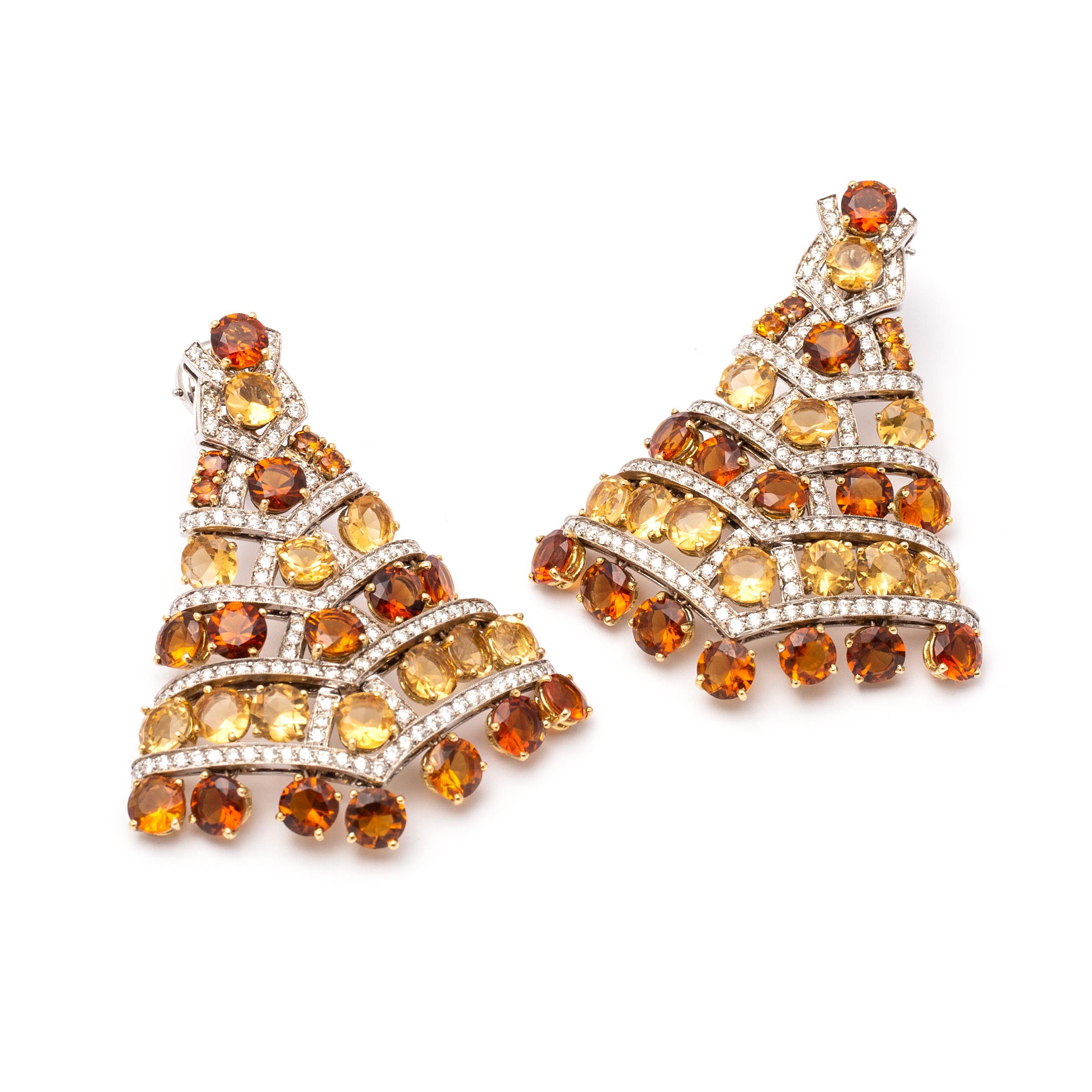 Pair of 18K two-color gold, citrine, quartz and diamond earlcips.
Michele della Valle.
The fan-shaped eaclips set with numerous round citrines and quartzes, accented by round diamonds weighing approximately 5.15 carats.
Signed MdV.