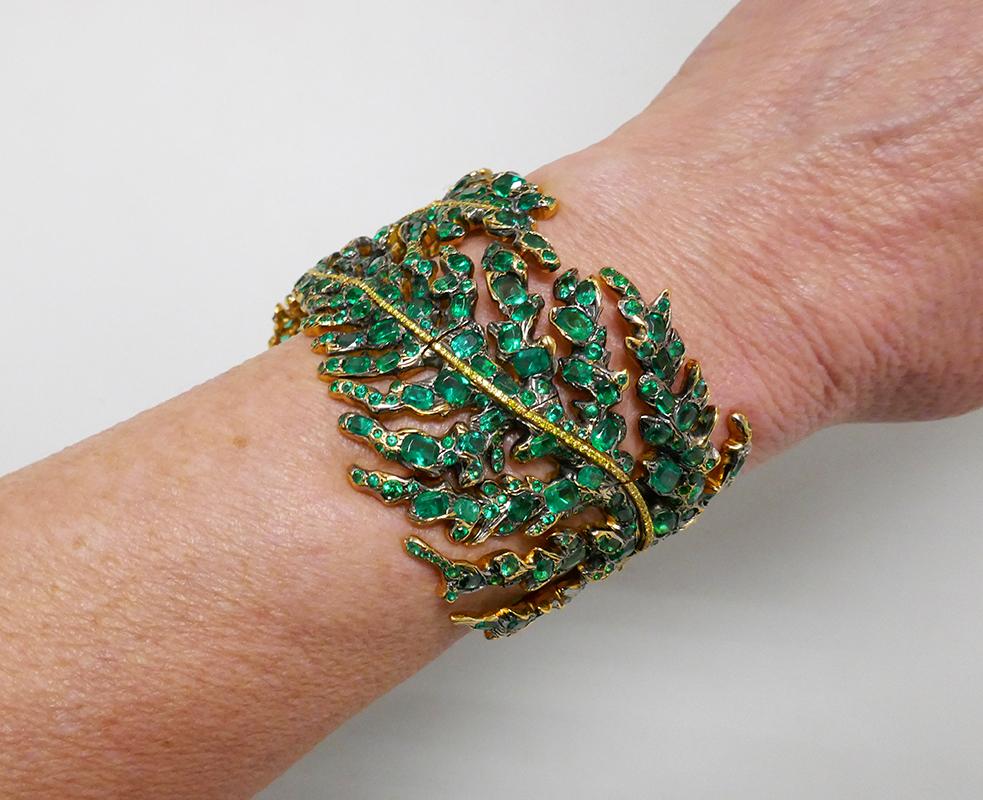 Magnificent fascinating bracelet created by Michele Della Valle in the 1990's. Bewitched floral design. The bracelet is made of 18k white and yellow gold and encrusted with emeralds and fancy yellow gold diamonds. Beautiful color combination!
The