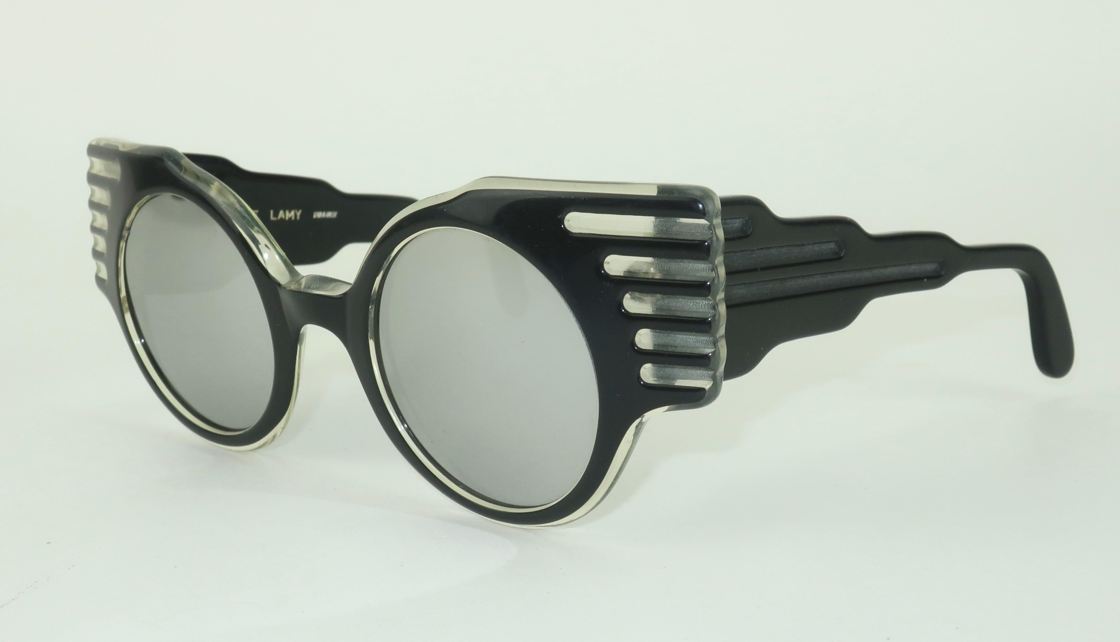 From the 'High Priestess of Paris' via 1980's Los Angeles, a fabulous pair of black sunglasses by designer, Michele Lamy.    These frames boast a unique silhouette with an angular style earning the moniker 'Cadillac Tailfin' sunglasses.  They have