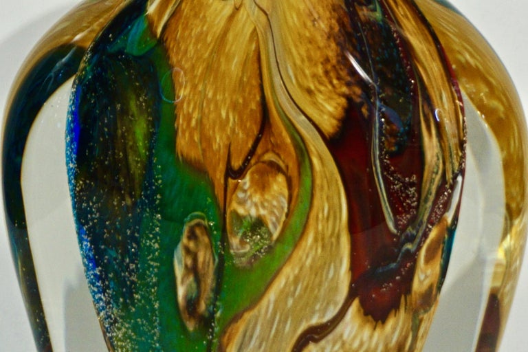 A modern Murano glass vase, signed Work of Art by Michele Onesto, extensively worked with blown Murrine in green, yellow, red plum, blue enhanced with silver speckles and precious calcedonia, overlaid in crystal clear Murano glass.
Weight 10.5 Ibs