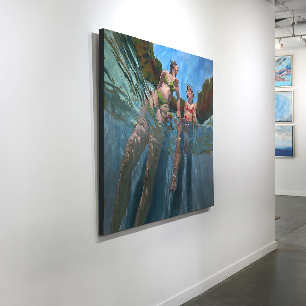This abstract figural painting by Michele Poirier-Mozzone captures two girls, one wearing a green bikini swimsuit, the other wearing red, from beneath the surface of water. The viewer looks upward at the two figures, who sit on the edge of the water