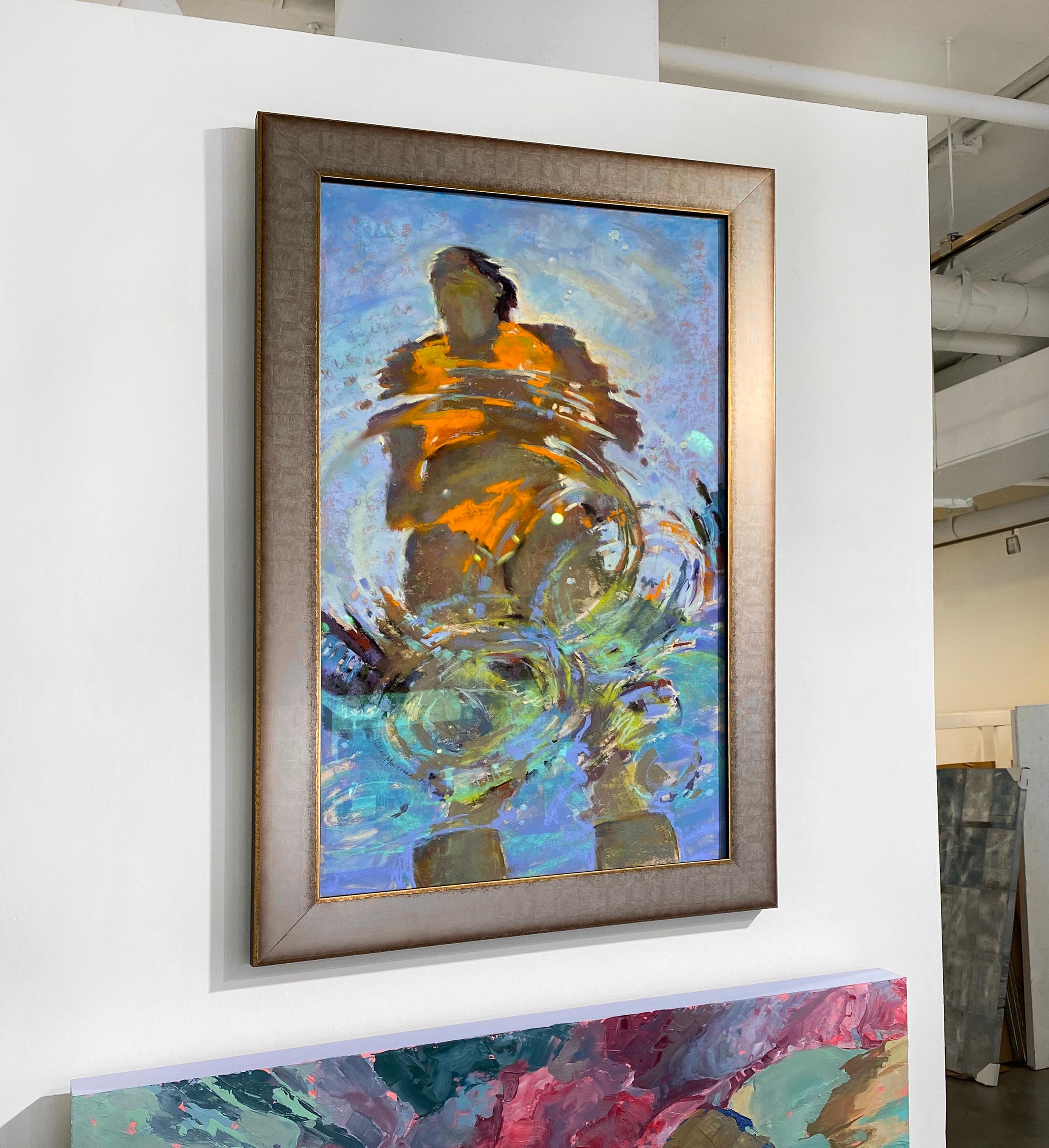 This abstract under water piece by Michele Poirier-Mozzone is captured from an angle beneath the surface of water, looking up at a woman wearing a bright orange bathing suit. The water's surface ripples, fracturing the figure with additional colors
