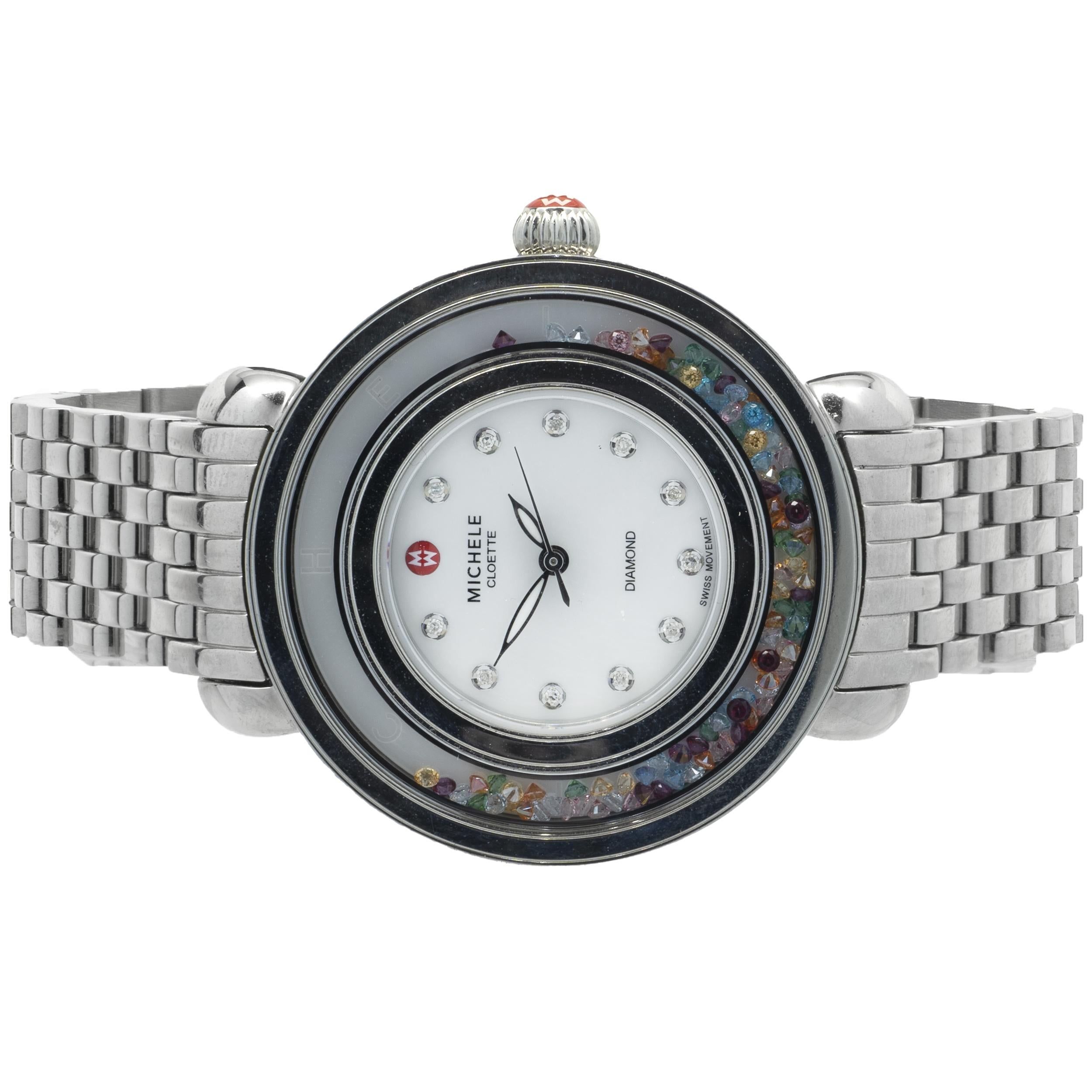 Movement: quartz
Function: hours, minutes, seconds
Case: 38mm stainless round case, floating multi colored topaz bezel, sapphire crystal
Dial: white diamond mother of pearl dial 
Band: stainless steel mesh bracelet
Serial #: HF0021XXX
Reference #: