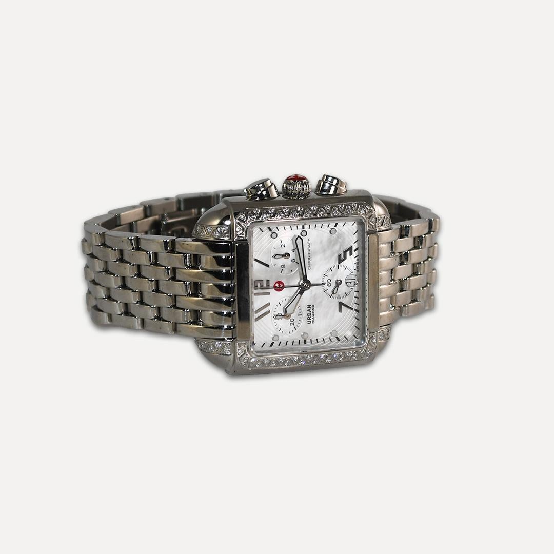 Ladies' large Michele urban diamond chronograph watch in stainless steel.
Quartz movement.
Keeps good time.
Mother of pearl dial.
The case size is 35mm by 28mm.
Measures 6 inches in length.
The bezel is set with 66 small round diamonds.
The watch