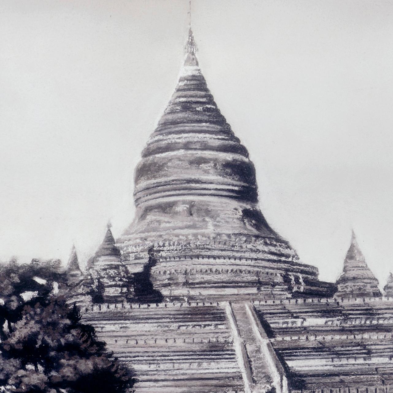 This black and white charcoal and pastel painting features a Burmese temple landscape. Rising from clouds of gnarled trees, the temple’s triangular shape thins to a pointed dome, with smaller turrets rising around each thinly striated layer of the