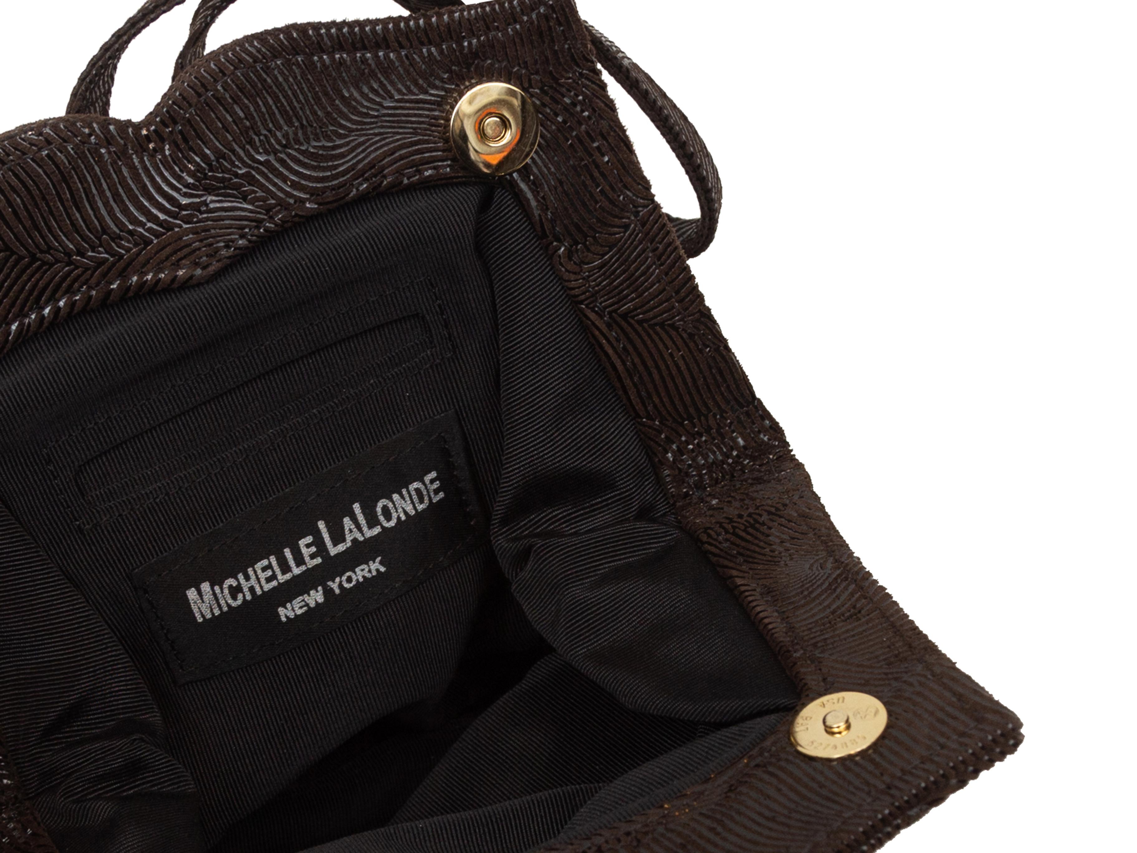 Product details: Dark brown swirl embossed leather evening bag by Michelle LaLonde. Interior pocket. Single handle. 6.5