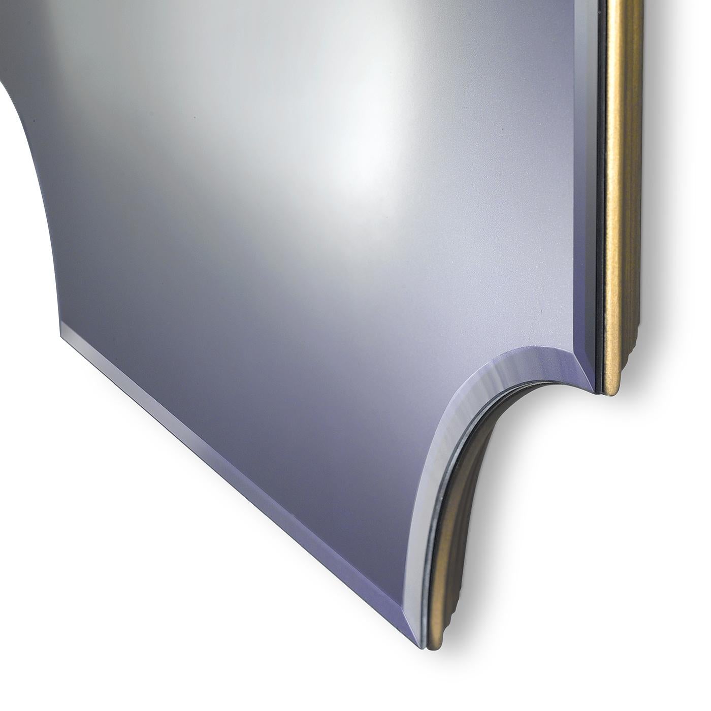 A modern and rectangular shaped mirror that features concave corners. The frame is made of wood with a riace bronze finish, however other finishes are available on request. The mirror, pictured here in purple, can be ordered in different colors.