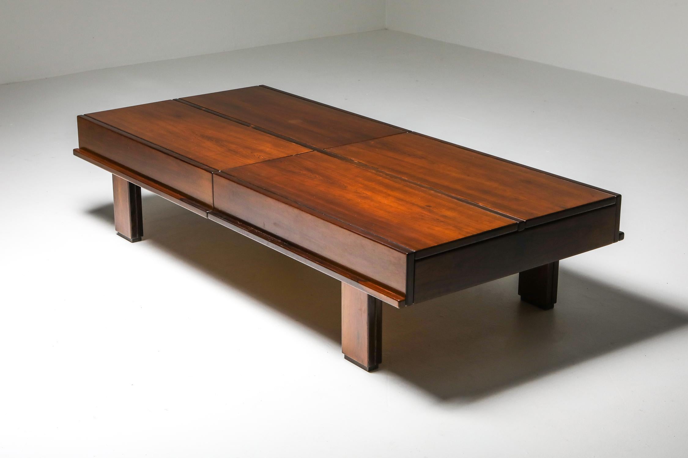 Mid-Century Modern solid wooden coffee table, Michelucci, Italy, 1970s

Solid walnut large coffee table which hides plenty of storage.
Each quarter of the table opens up to reveal storage space.
Impressed by the design and functionality of this