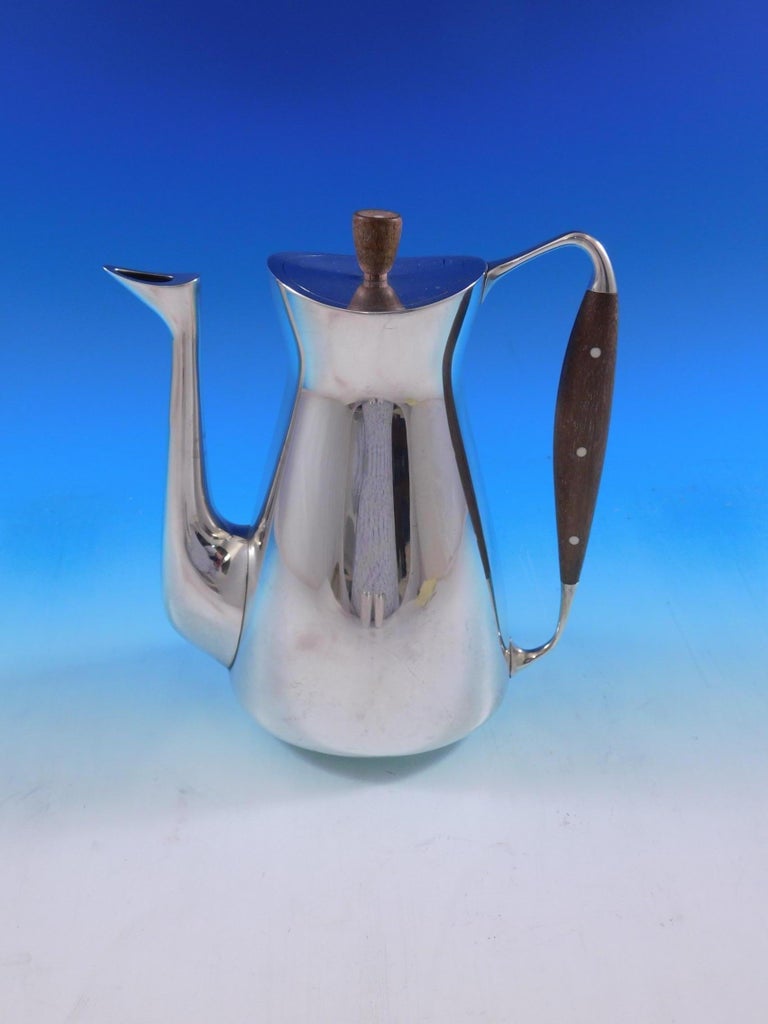 Michelsen

Modernist Danish sterling silver 3-piece coffee set made by Michelson. It has a wood handle and finial inlaid with three bone disks. The piece dates from the 1940s-1950s. This set includes:

1 coffee pot - 8 1/4