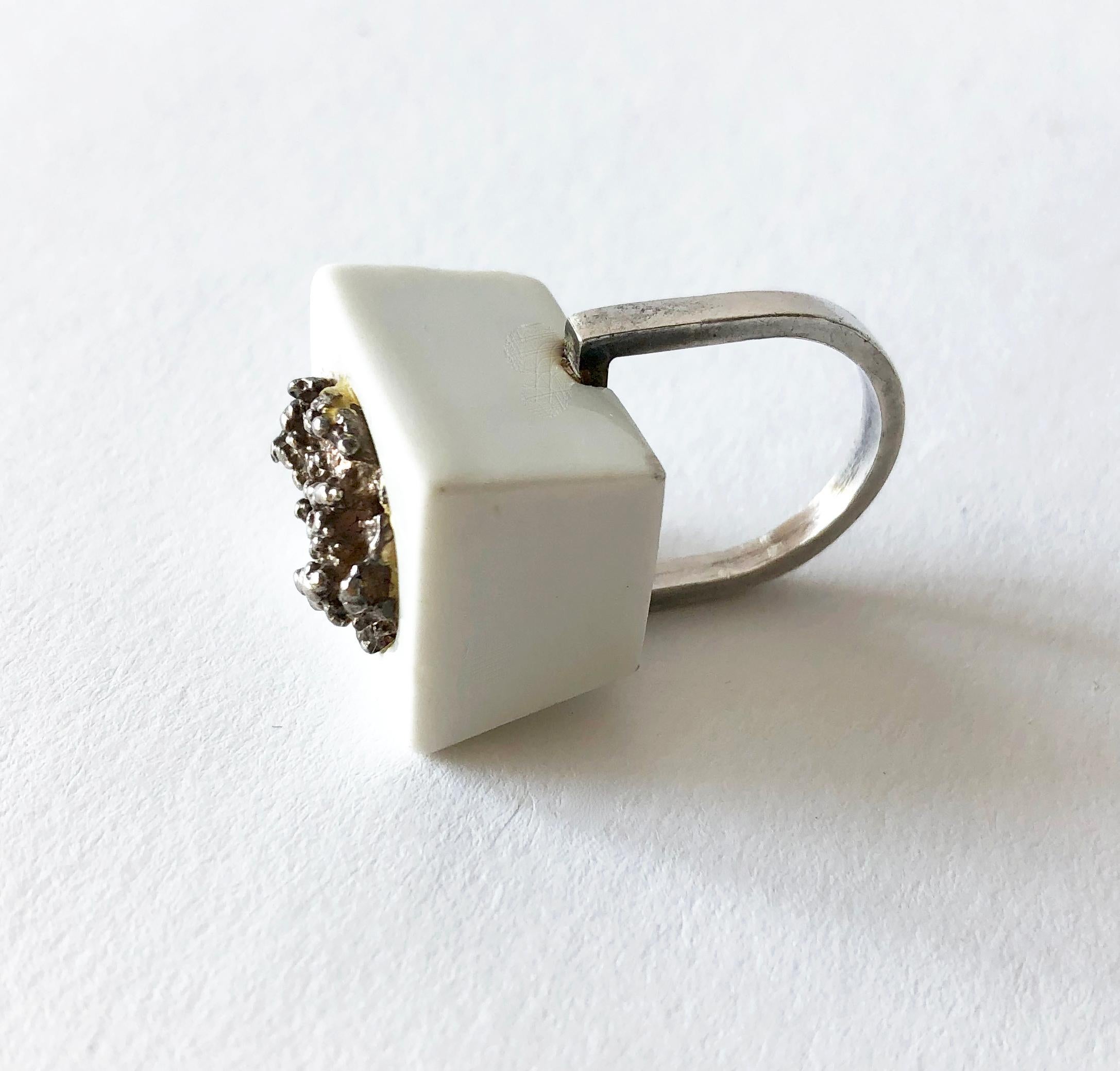 1960's Danish modernist Royal Bini ring created by Anton Michelsen for Royal Copenhagen of Denmark. Ring is a finger size 6 and made up of a porcelain cube with molten sterling silver center accent.  Ring sits about 5/8