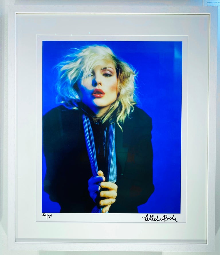 Debbie Harry photographed in New York City in 1978.

TITLE: Blue Blondie 1978
PHOTO: Mick Rock 
SIGNED LIMITED EDITION 21/90 
PAPER: Silver Gelatin Fibre Print
FULLY FRAMED: 21 x 25.5 INCH
PICTURE SIZE: 17.7 x 15 INCH
PAPER SIZE: 20 x 16 INCH