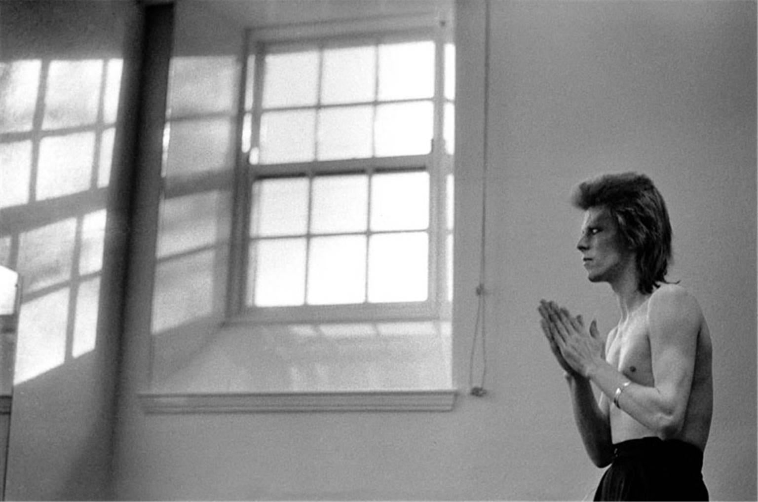 Mick Rock Black and White Photograph - David Bowie, Praying By Windows, Scotland, Summer 1973