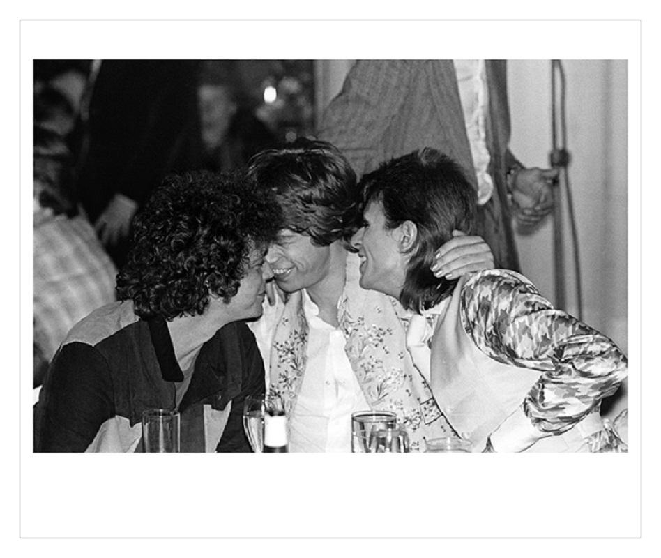Reed Bowie Jagger Hug - Limited Edition Mick Rock Estate Print 

Lou Reed, Mick Jagger and David Bowie share a hug, Café Royal, London, 1973 (photo Mick Rock).

All prints are numbered by the Estate 
Edition size varies according to print