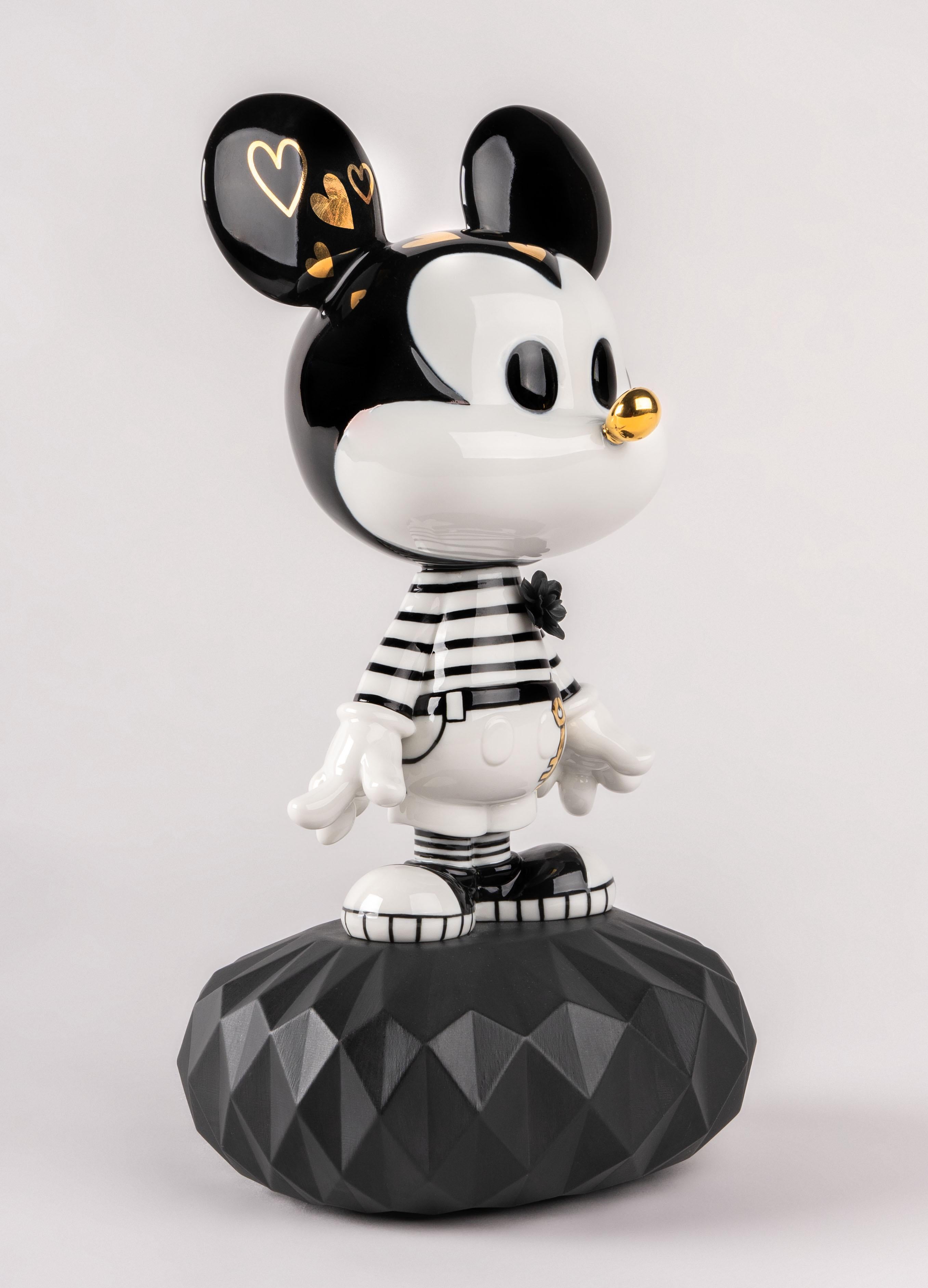 This creation is based on a contemporary vision of Mickey Mouse. The creative approach taken is based on the cartoon technique and contains black ink strokes on white. And so, Mickey is decorated with hand painted drawings on porcelain, symbolizing