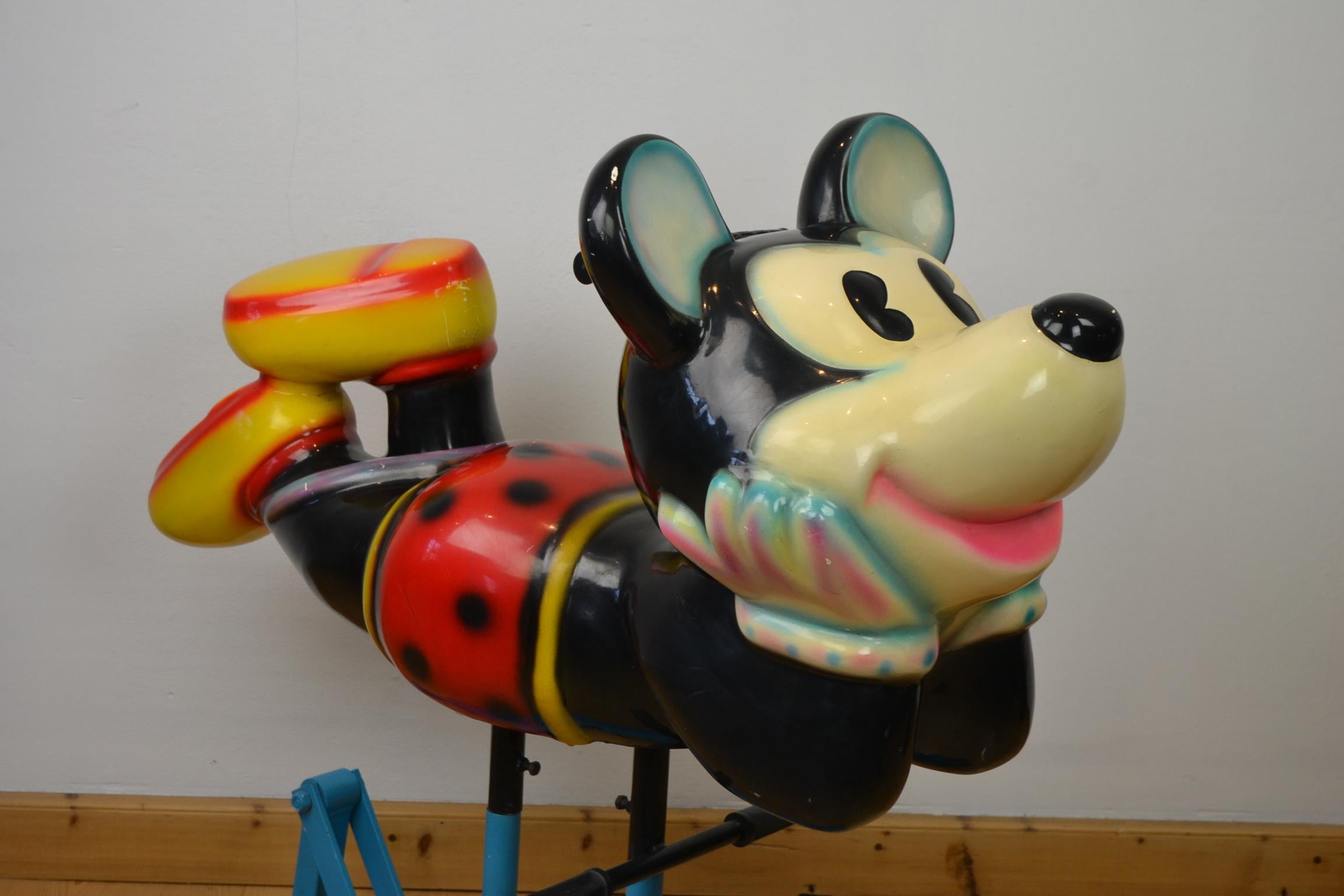 Mickey Mouse carousel figure or mickey mouse seat. 
This carousel seat is in the shape of the well-known animated cartoon Disney character Mickey Mouse or Mickey
which is mounted on an iron swing. The Mickey Mouse figurine is made of polyester.