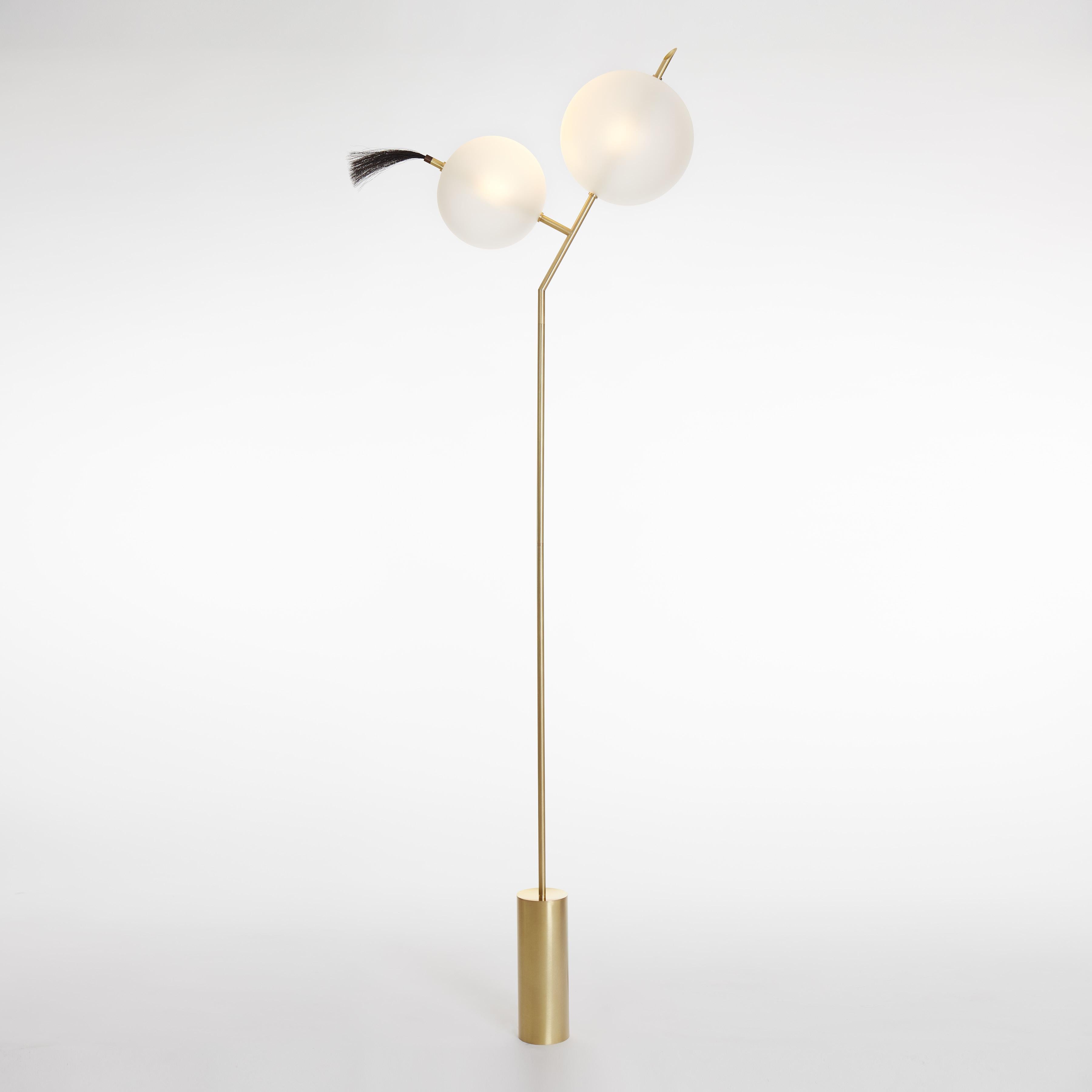A playful nod, as the name suggests, to the world of cartoons, Mickey floor light is a Minimalist Contemporary Standing Lamp composed of two closely positioned glass spheres of different sizes.
As an option, on request, the horsehair detail can