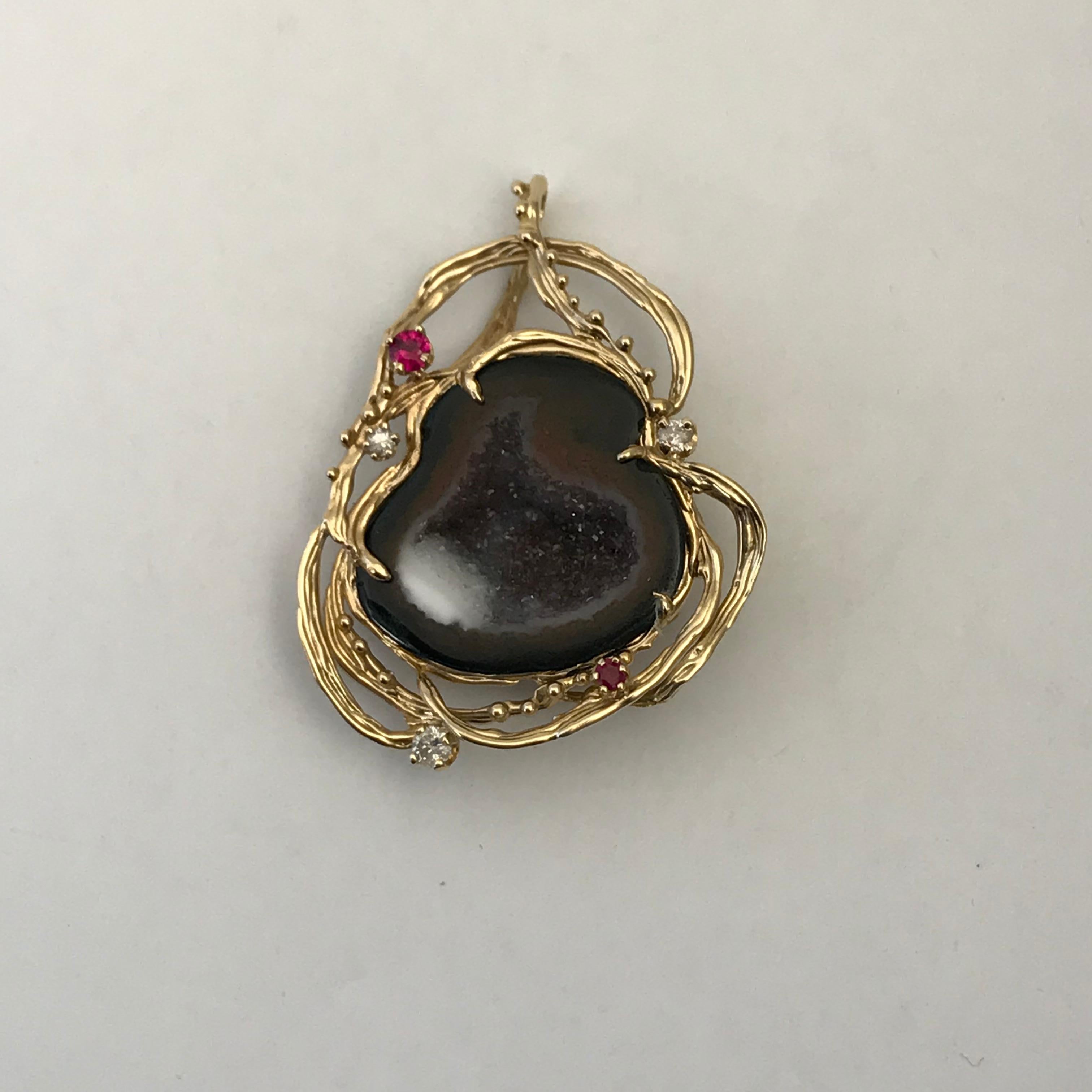  Micro Geode Pendant in 14 K Yellow Gold 

This Micro Geode pendant is set in 14k yellow Gold.  The gold is free-form around the geode with Sapphires & Diamonds surrounding the outside of micro geode. It is 100% natural in color nothing about it has