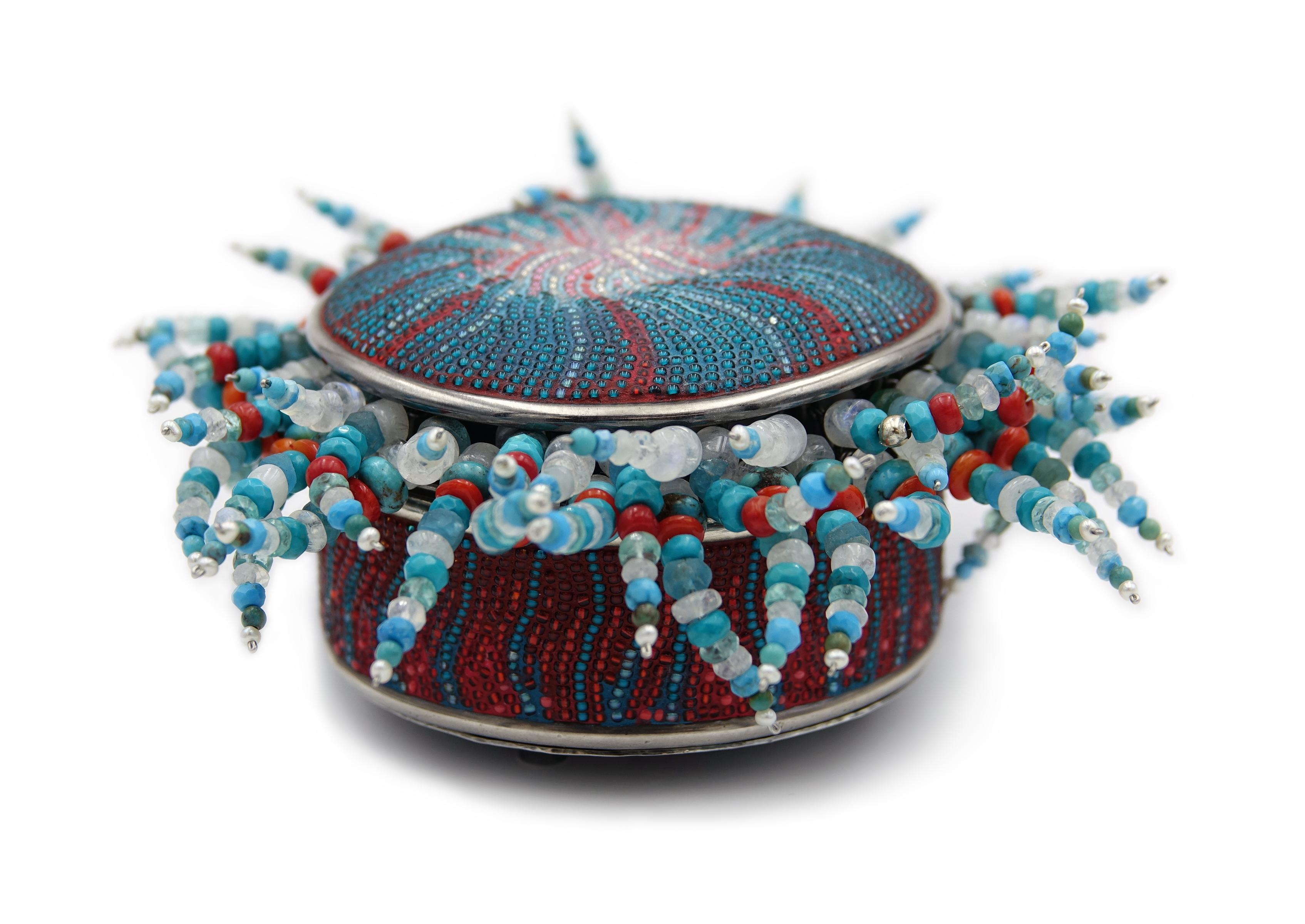 Anemone Jewelry Suite is a micro-mosaic jewelry box made of 85 sterling silver parts, including handmade screws and bolts, glass seed bead micro-mosaics, moonstones, coral, turquoise, and pearls. Box transforms into a convertible pendant/brooch,