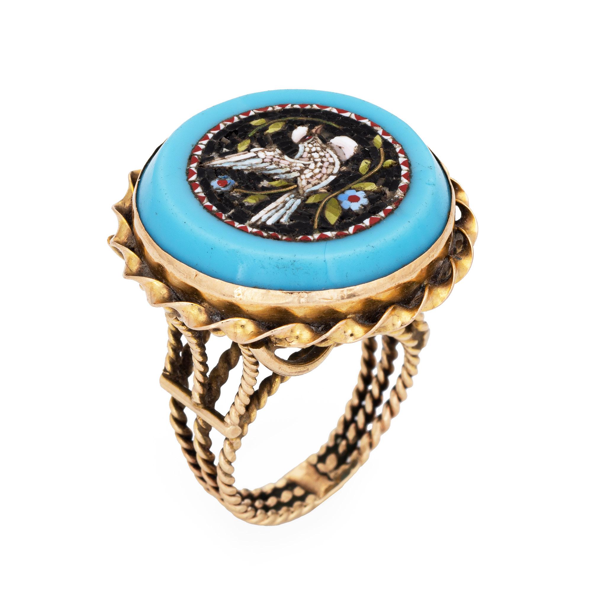 Finely detailed vintage micro mosaic cocktail ring crafted in 14 karat yellow gold. 

Tiny tiles of small colored glass form the image of a bird in full flight (we believe the bird is a dove), set flush into a blue stone mount. Micro mosaic jewelry