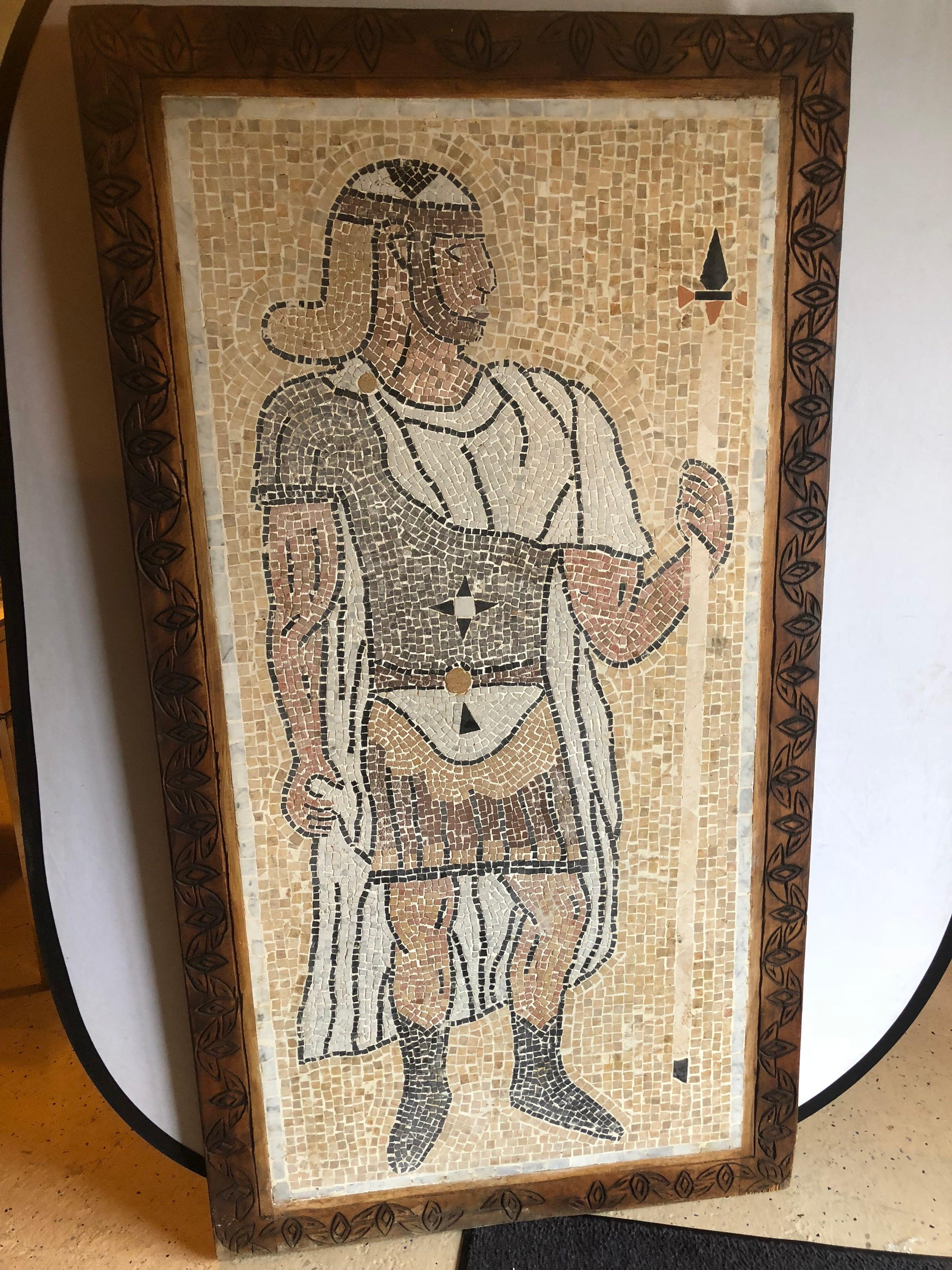 A Mid Century Italian Mosaic Tile Wall Plaque or Table Top of a Centurion in Wood Carved Frame. The palatial micro mosaic tile wall art shows  a centurion standing tall and holding his spear. The tile plaque comes in a beautifully carved and