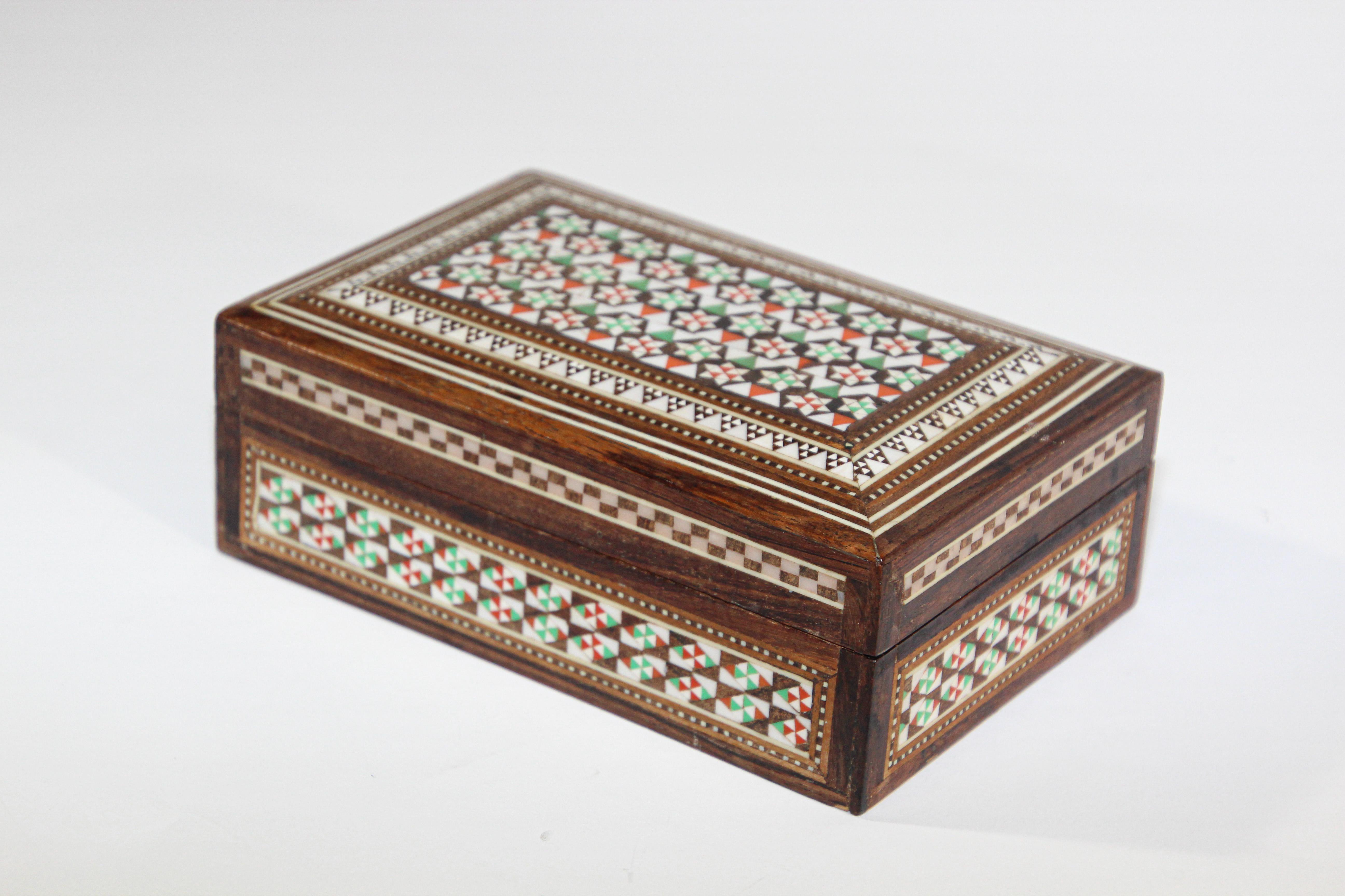 Handcrafted marquetry Moorish wood inlay micro mosaic with miniature hand painted scene.
Handcrafted khatam wooden box with very delicate micro mosaic marquetry from the ancient Persian technique of inlaying from arrangements of so many delicate