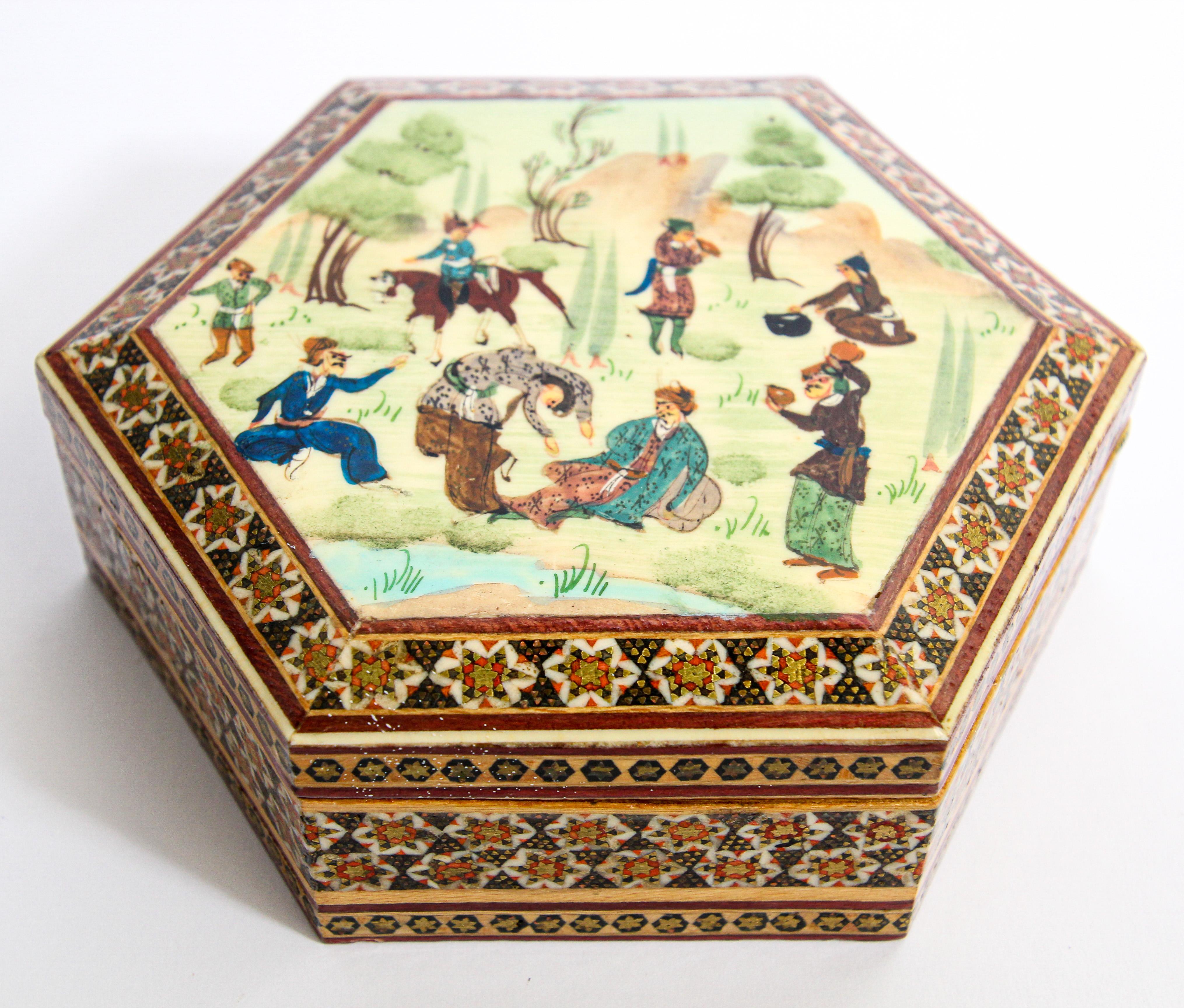 Handcrafted Middle Eastern wood inlay micro mosaic marquetry with miniature hand painted scene.
Handcrafted khatam hexagonal shape wooden box with very delicate micro mosaic marquetry from the ancient Persian technique of inlaying from arrangements