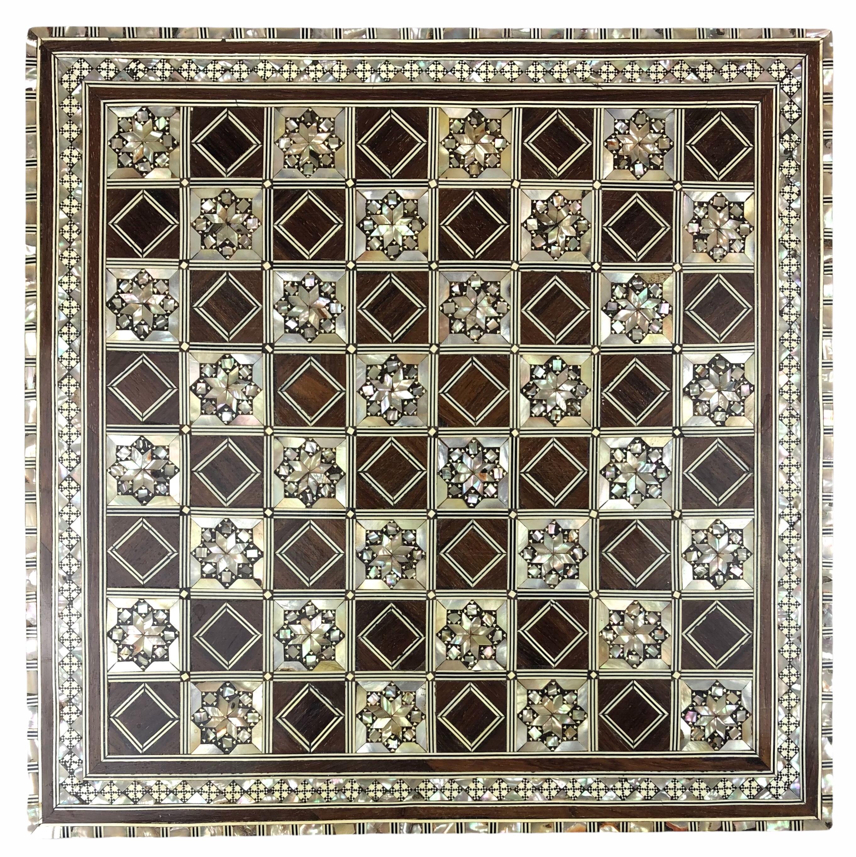 Vintage Moorish style mother-of-pearl and wood inlay chess game board.
Wonderful craftsmanship intricate marquetry in mosaic Moorish geometric pattern, mother-of-pearl inlay and fine precision makes it a true work of art.

Handcrafted in the Middle