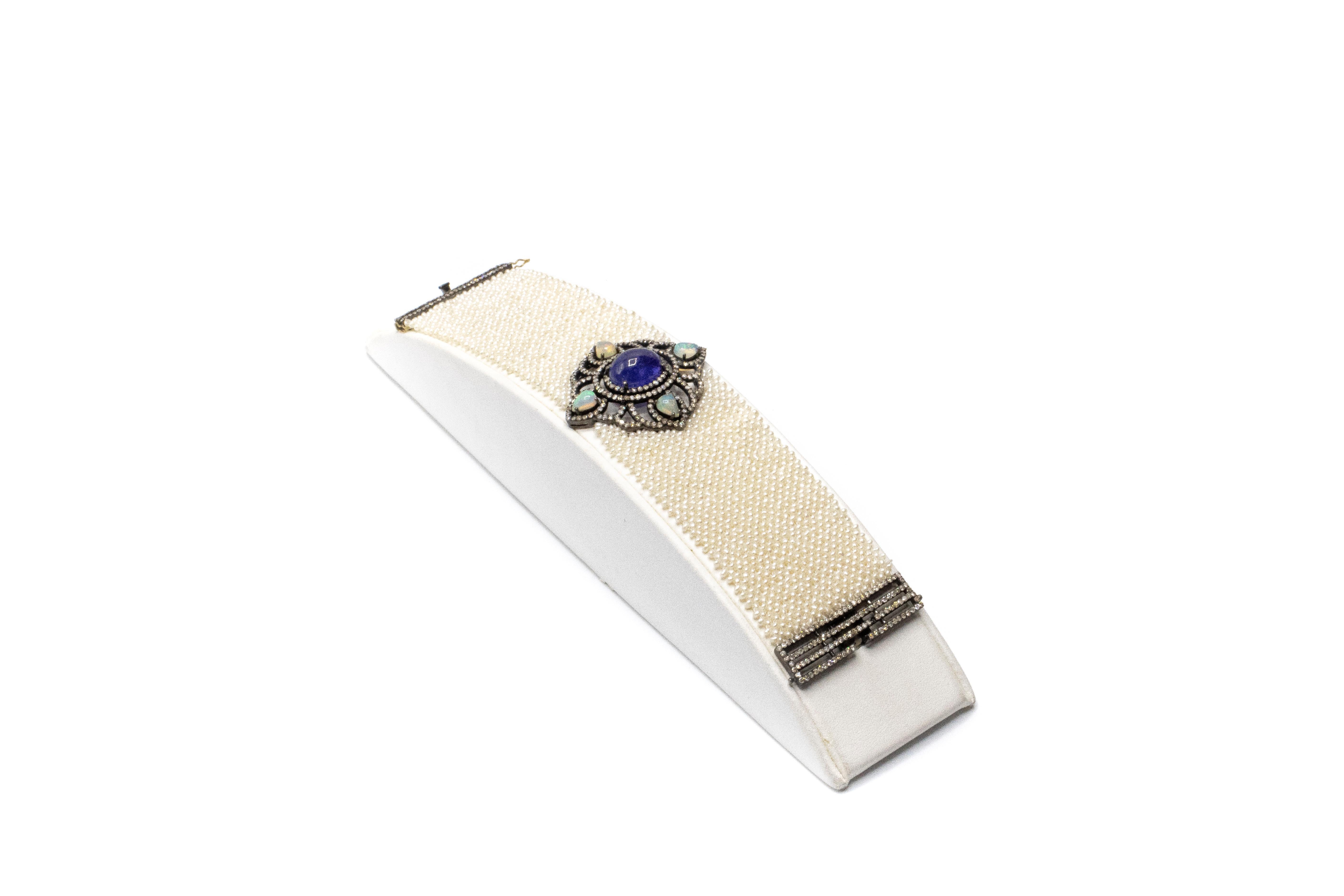 Micro Pearl Tanzanite Welo Opal Diamond Gold and Silver Choker Bracelet. Bracelet is beautifully adorned with four pear shaped Ethiopian Welo opals, a tanzanite cabochon, diamonds and hundreds of multi stranded tiny pearls. Total weight 34.70 grams 