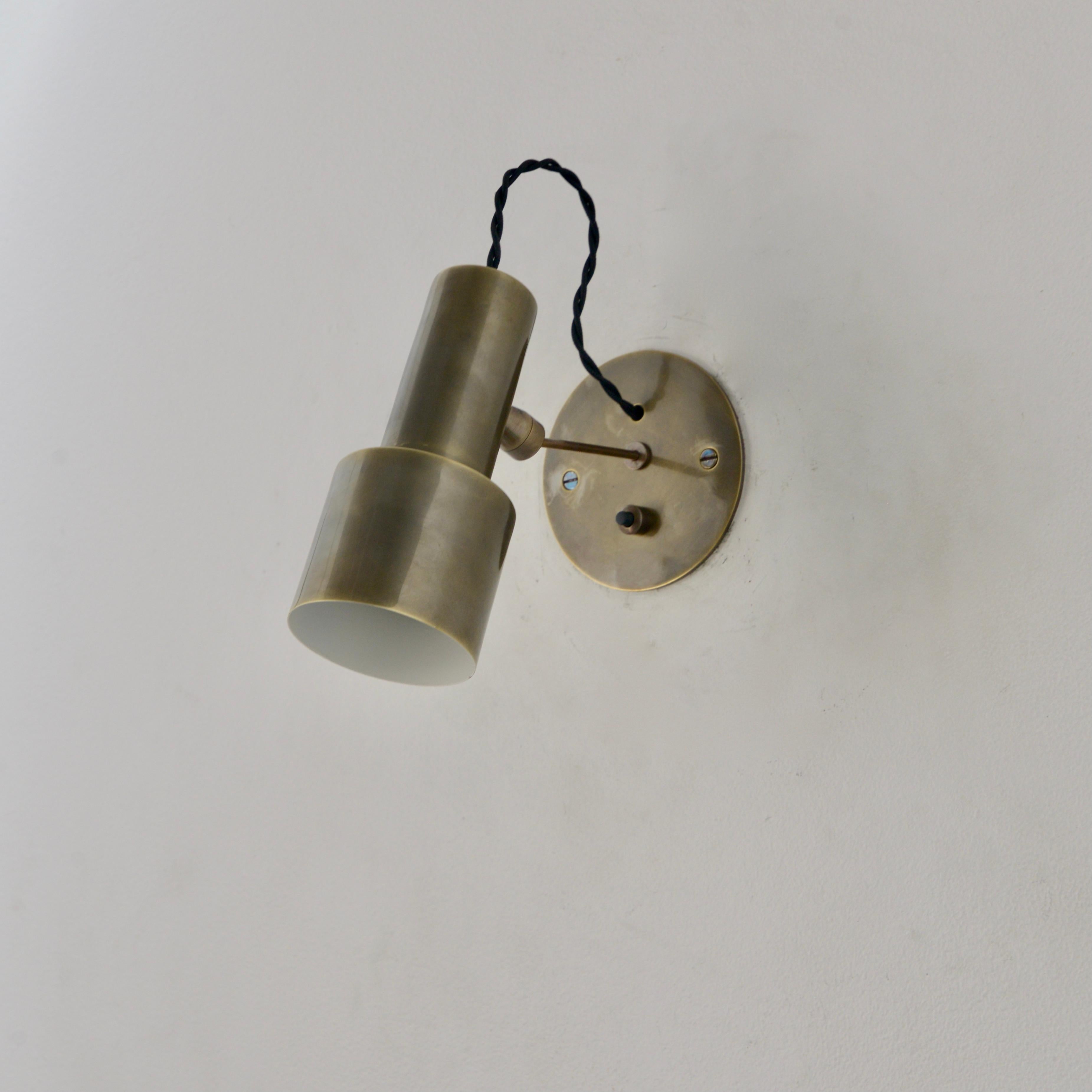 Beautiful patinated brass MicroLU articulating wall sconce by Lumfardo Luminaires. Made contemporary in the US. In all brass patinated finish with push switch. Multiples available for order. Can be wired for use anywhere in the world. Lightbulb