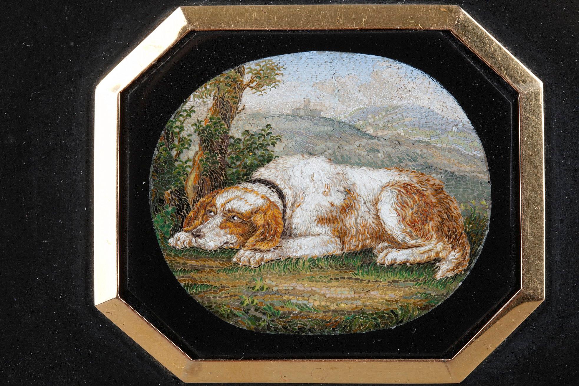 A rectangular marble paperweight with octogonal inlaid micromosaic plate. The plaque depicting a spaniel in a landscape, the trunk os a tree in this left.
Depictions of dogs in micromosaic were very popular as par of romantic genre, being symbolic