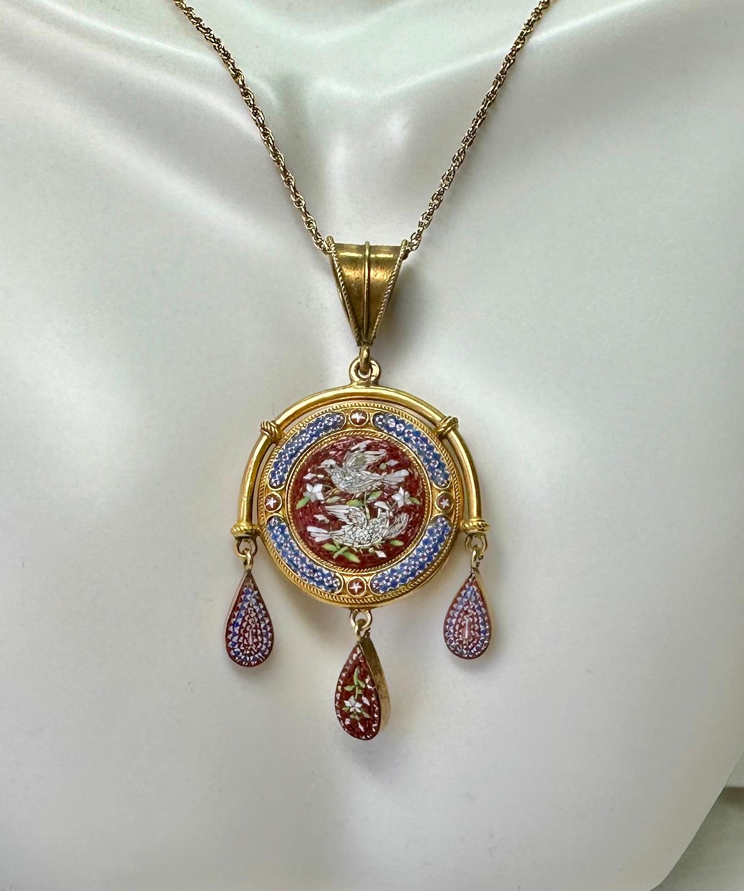 This is a museum quality Antique Micro-mosaic Locket Pendant finely crafted in high carat gold with a magnificent image of two love birds or doves with flowers on a red background in an Etruscan Revival pendant drop design of great beauty.   The