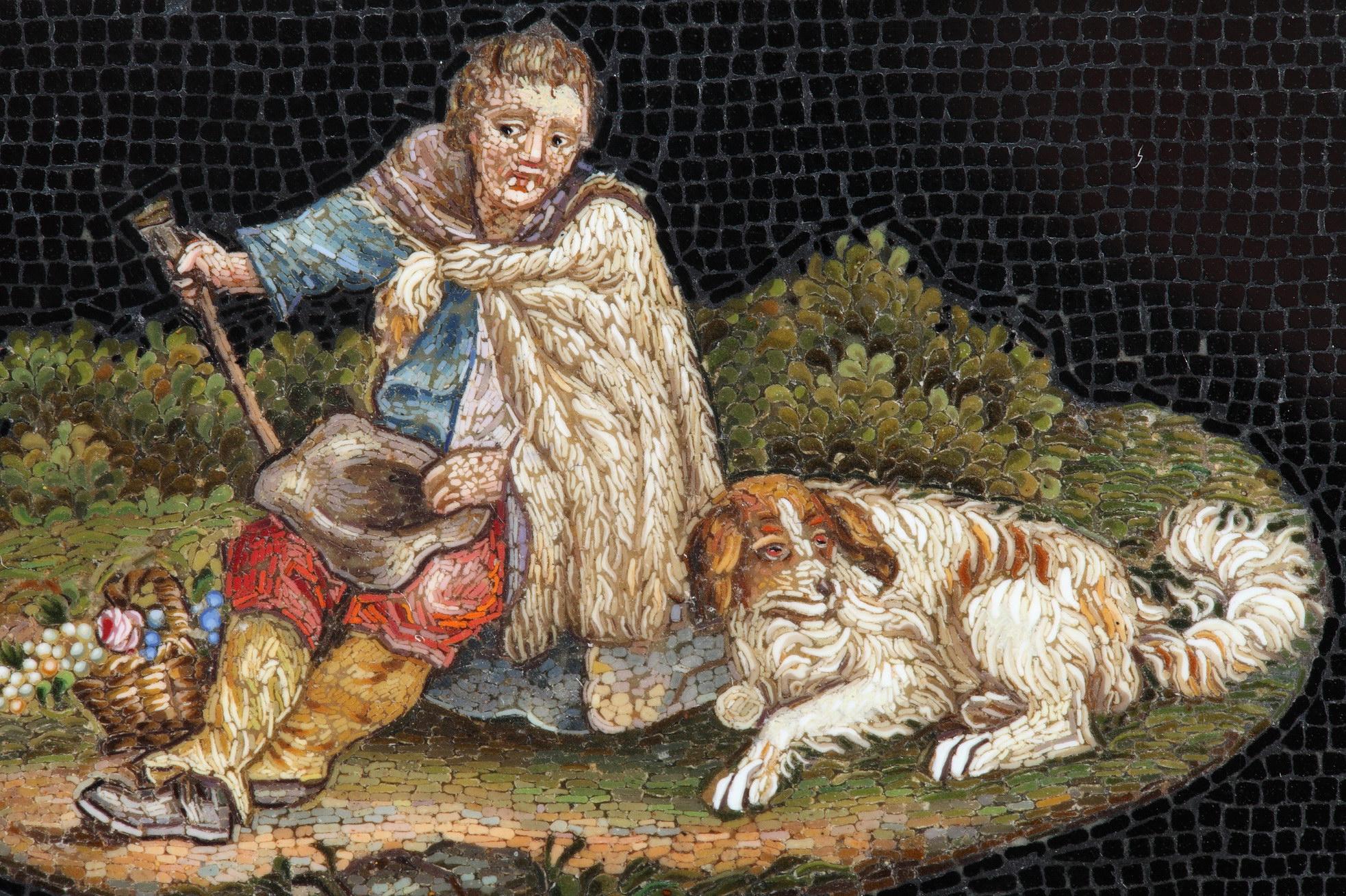 Rectangular micromosaic plate featuring a shepherd, seated and resting with his dog at his feet. The shepherd is wearing a woolen cloak over his colorful clothes. He is holding a hat in his left hand and his staff in his right. A wicker basket at