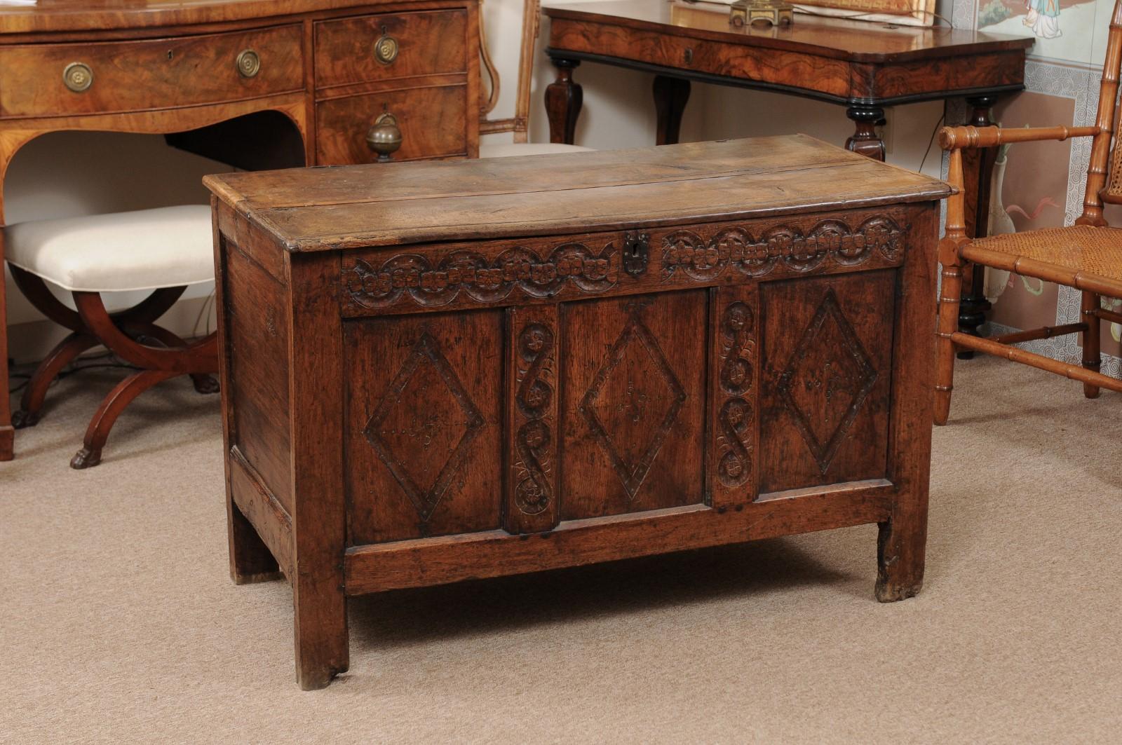 Oak hinged top trunk/coffer with lozenge carved panels, 17th century, England.
